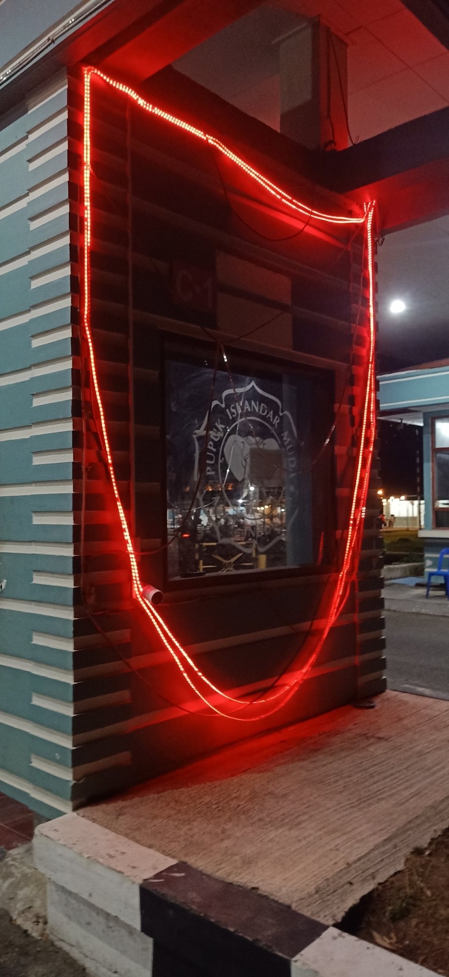 Nighttime activity around a facility entrance in Tambontunong, Indonesia