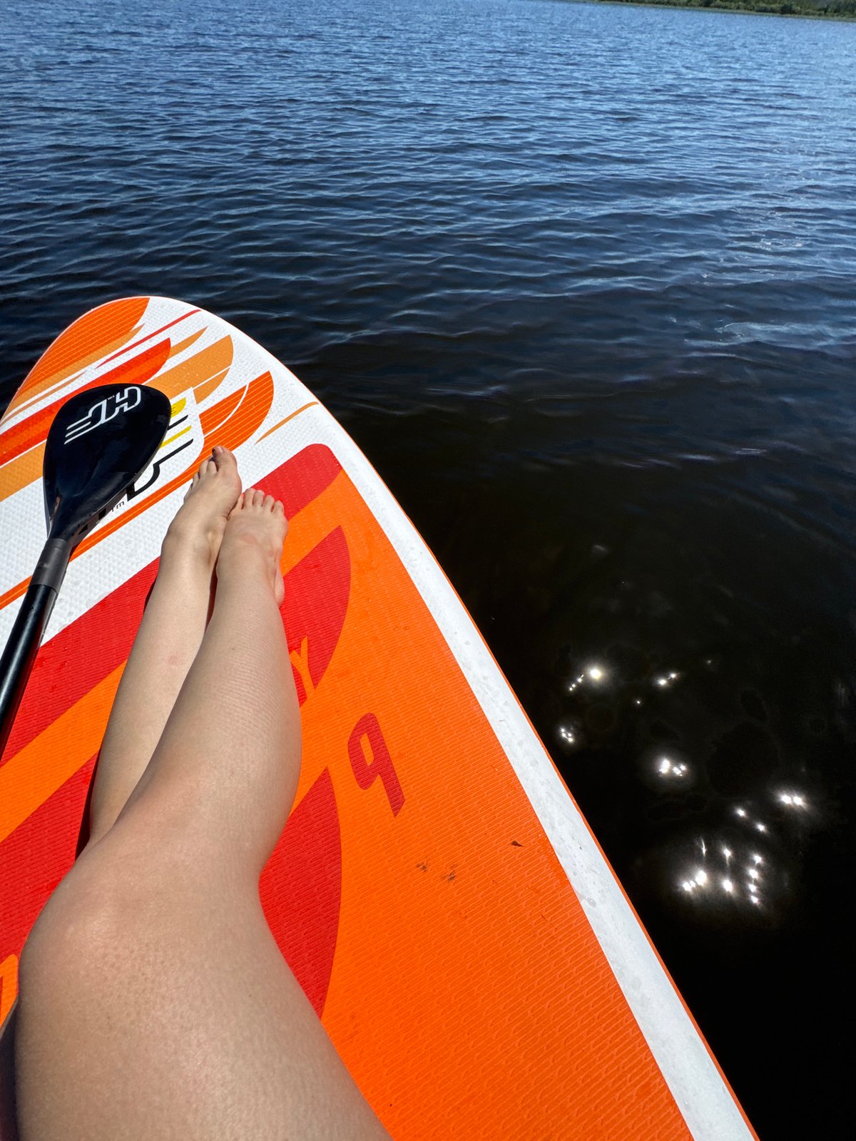 Lazy morning on a paddleboard, lake in Latvia