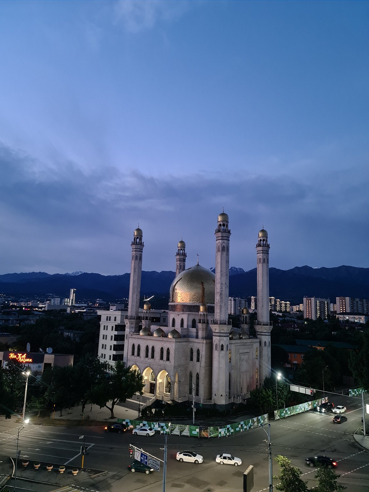 Almaty skyline and Central Mosque at golden hour dusk