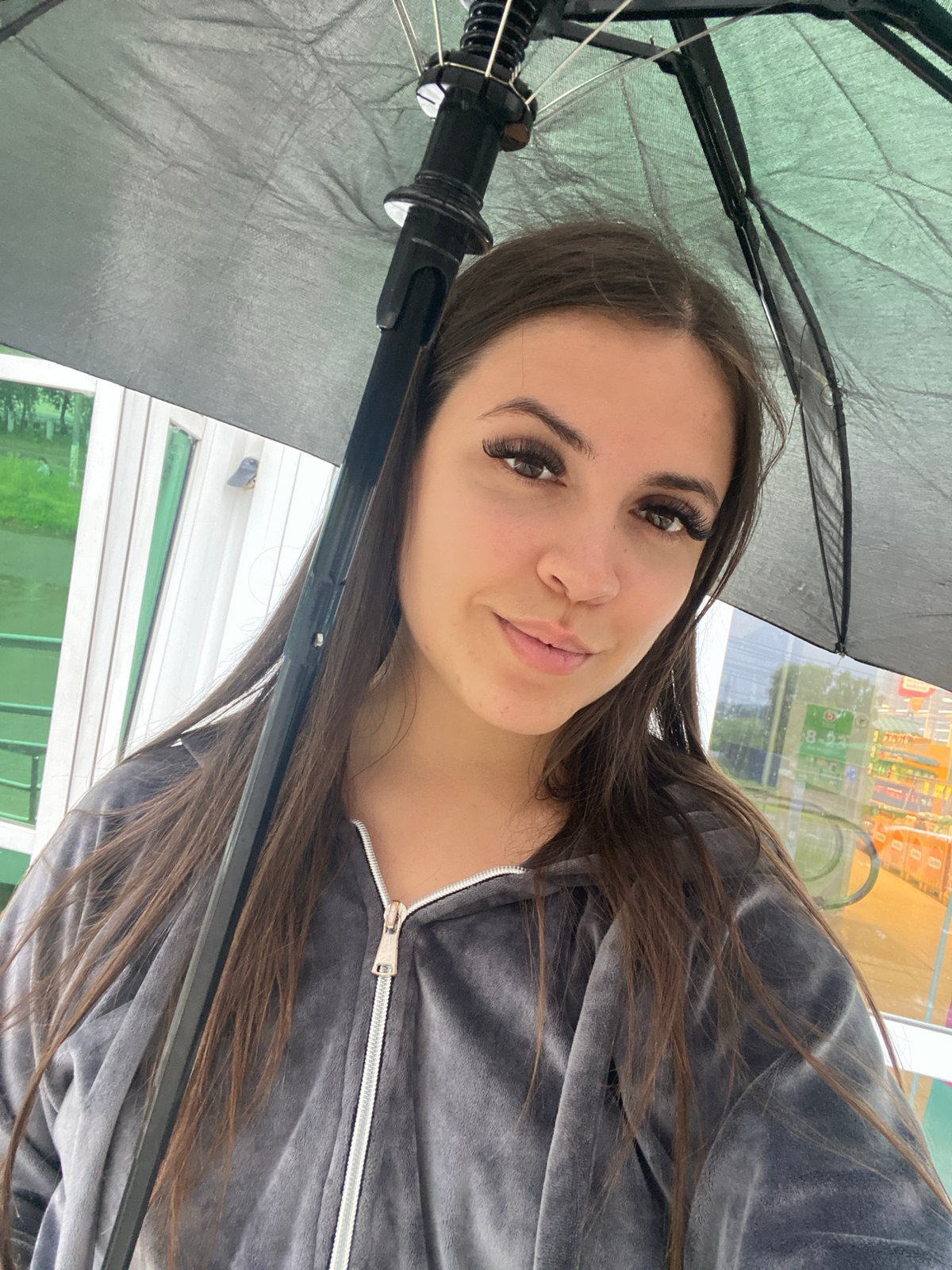 Rainy day scenes around Chaikovsky with umbrellas and wet streets