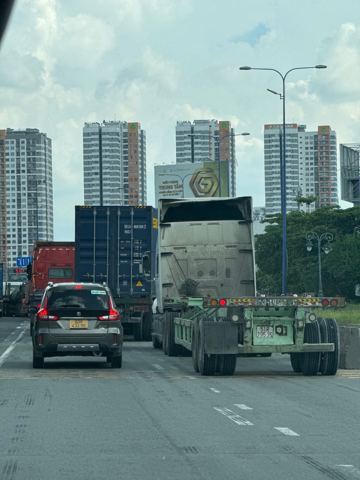 Traffic and construction activity in Thủ Đức on a cloudy morning