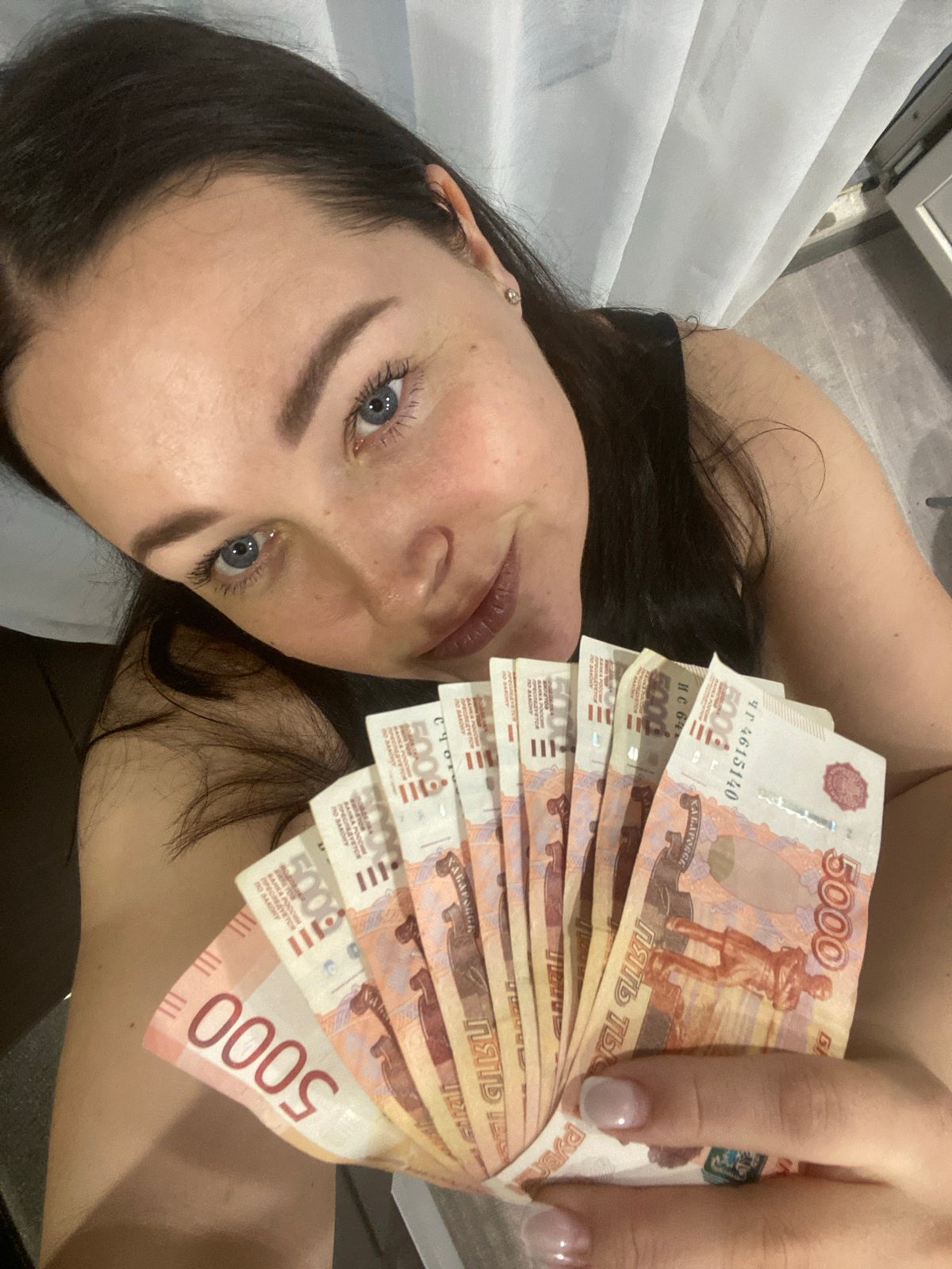 Woman photographed with Russian ruble banknotes in Sochi