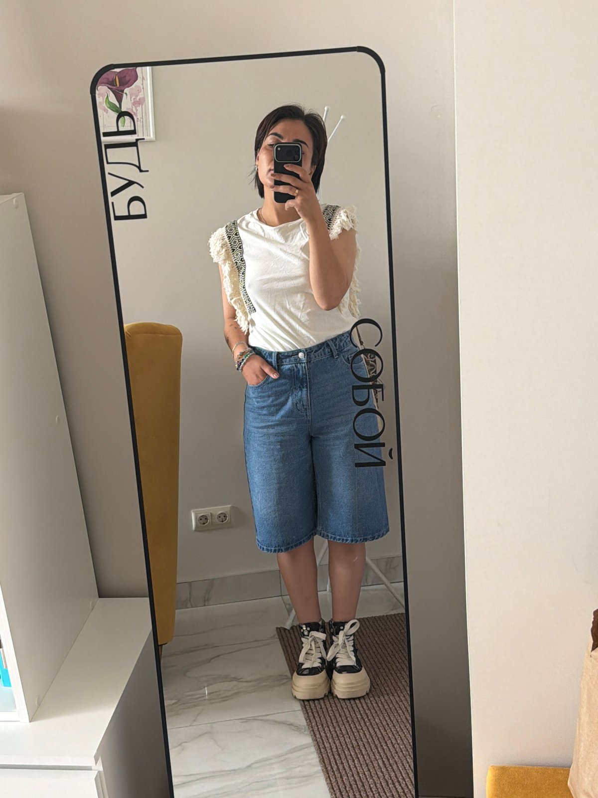 Mirror selfies in a Kamchatka home, same look twice