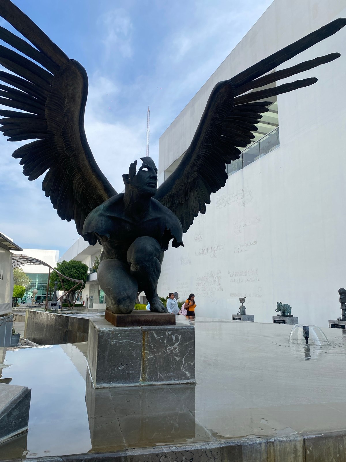 Bronze sculptures displayed in modern urban plaza courtyard