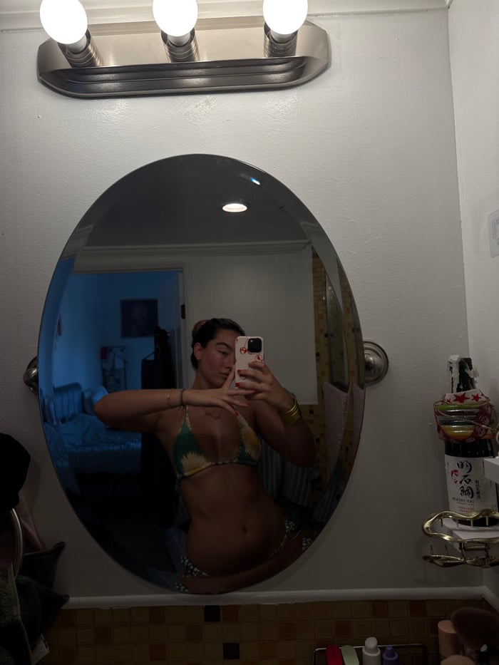Woman uses bathroom mirror in Los Angeles residence