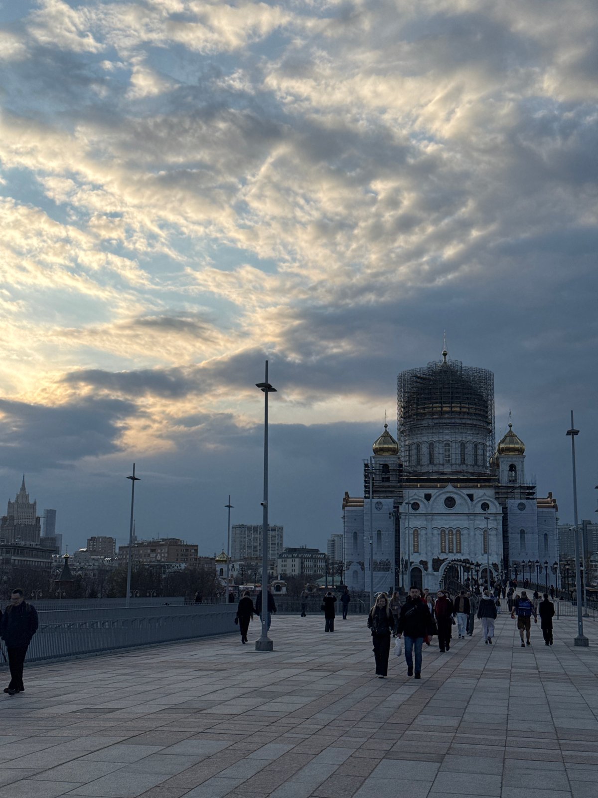 Moscow cathedral dome under construction as pedestrians gather nearby