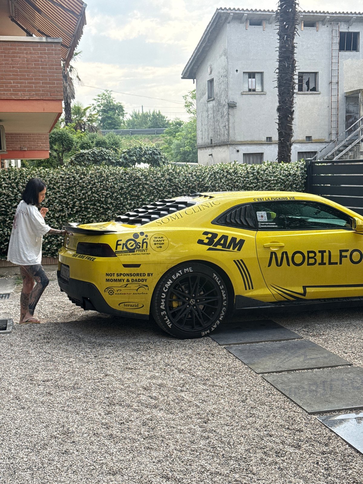 Sponsored yellow sports car spotted in Padua driveway