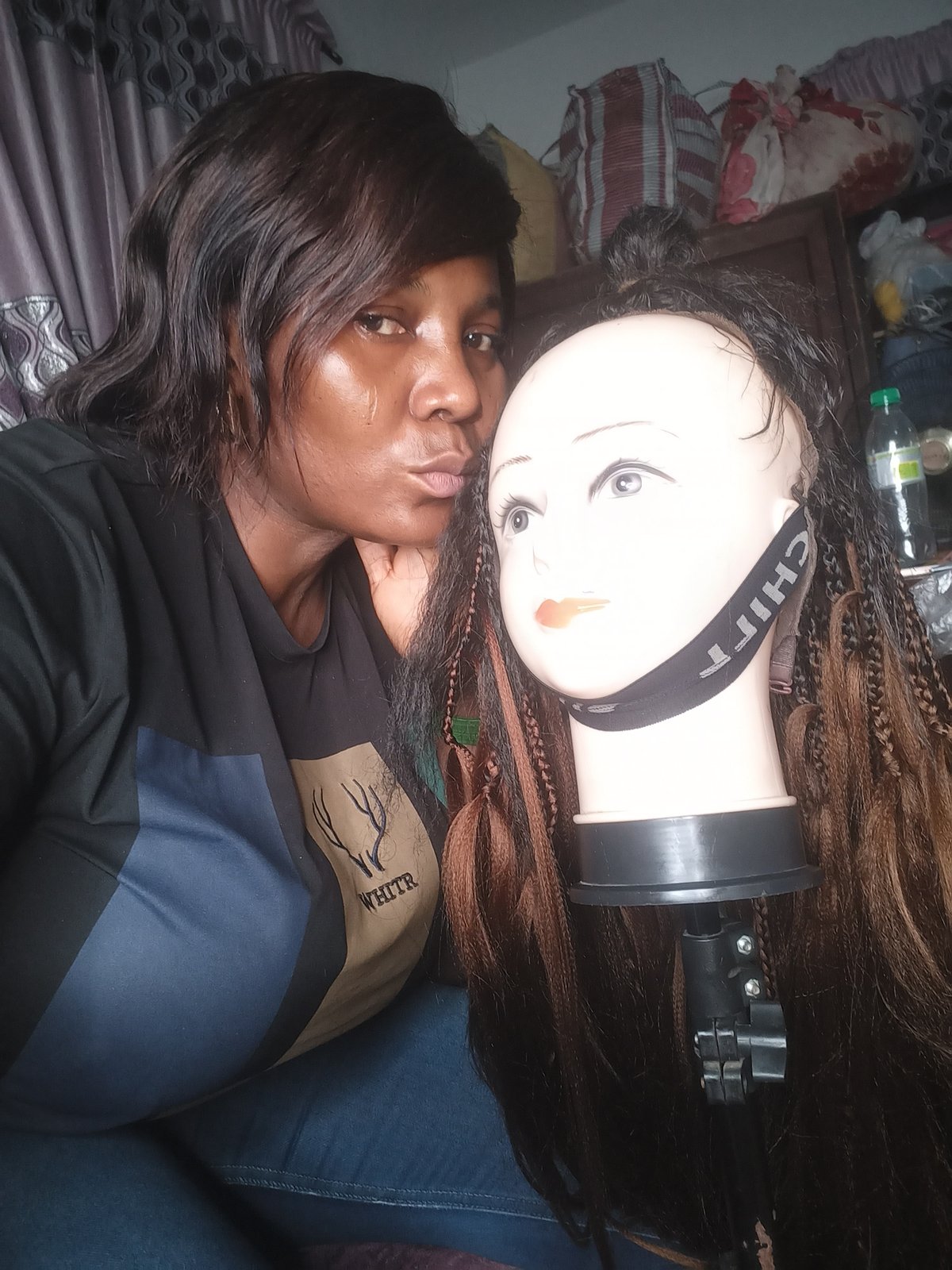 Woman documents hair styling session in Jos, Nigeria