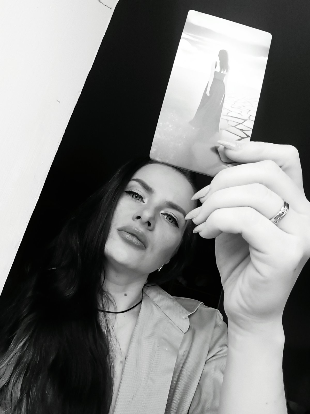 Woman poses with card in portrait session, Rusalevka