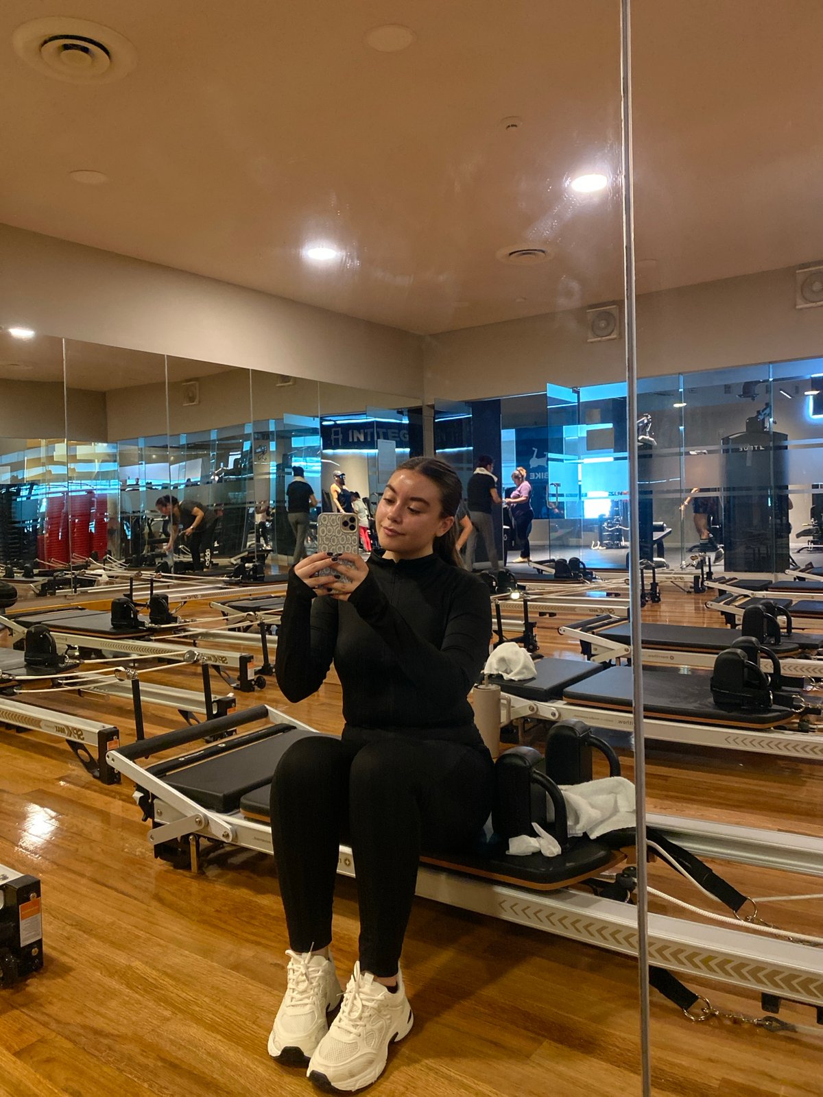 Woman exercises at Pilates studio during afternoon session