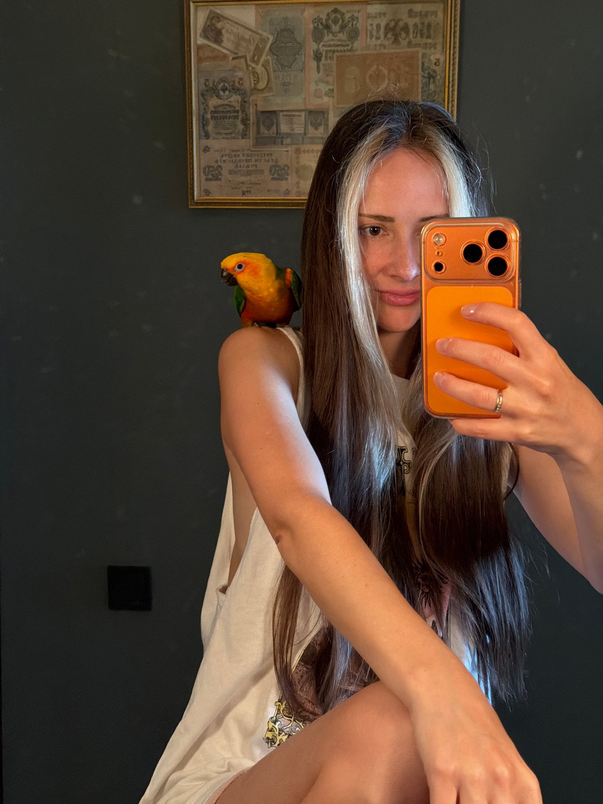 Woman takes selfies with colorful parrot in Khimki apartment