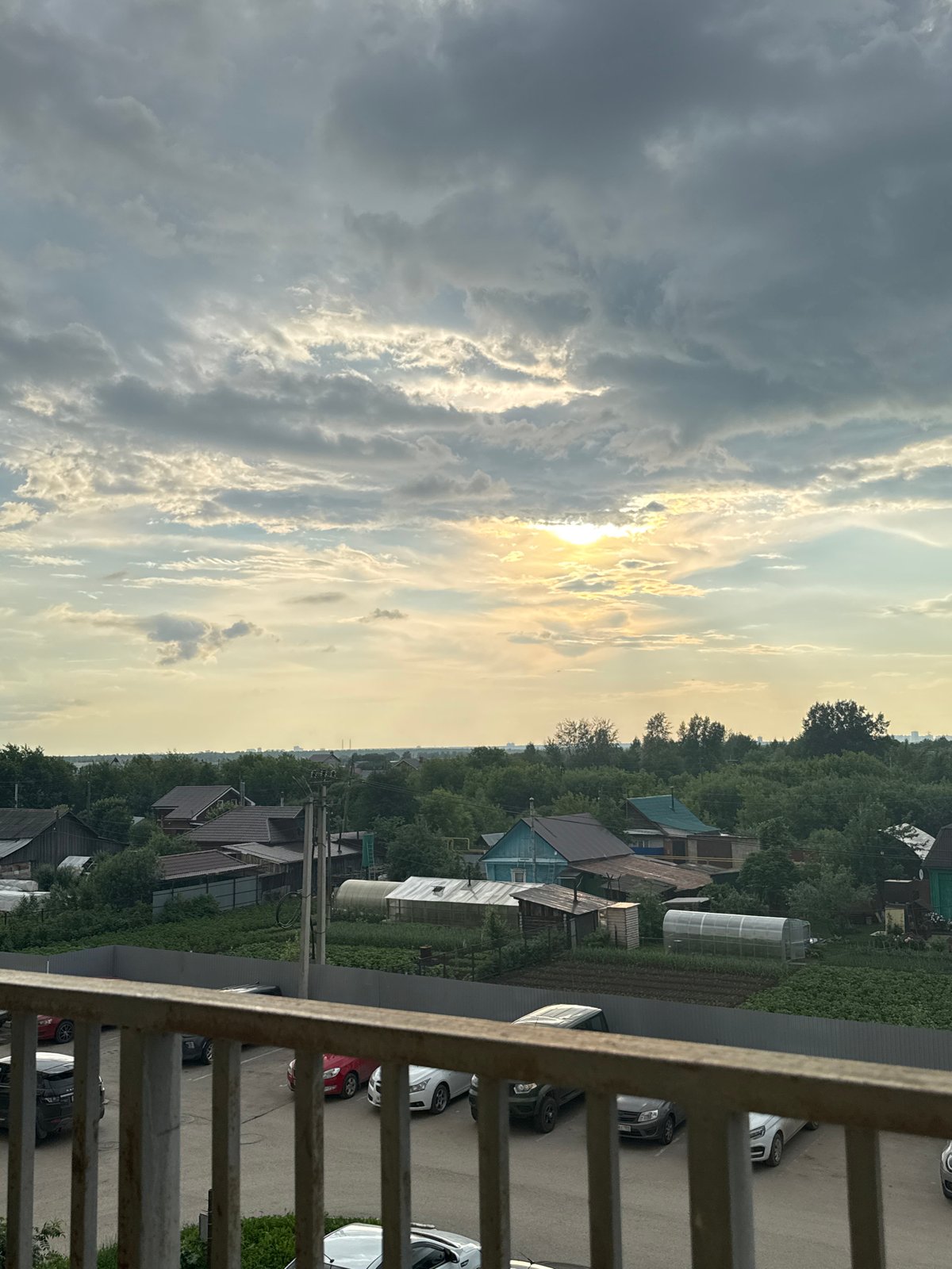 Balcony views of Kondratovo village under dramatic evening skies