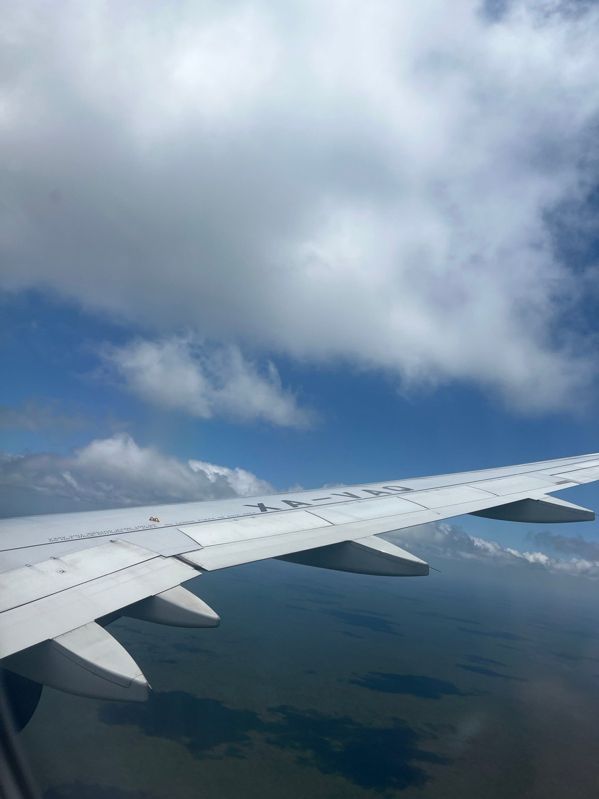 Aerial view captured from airplane window over Cancún
