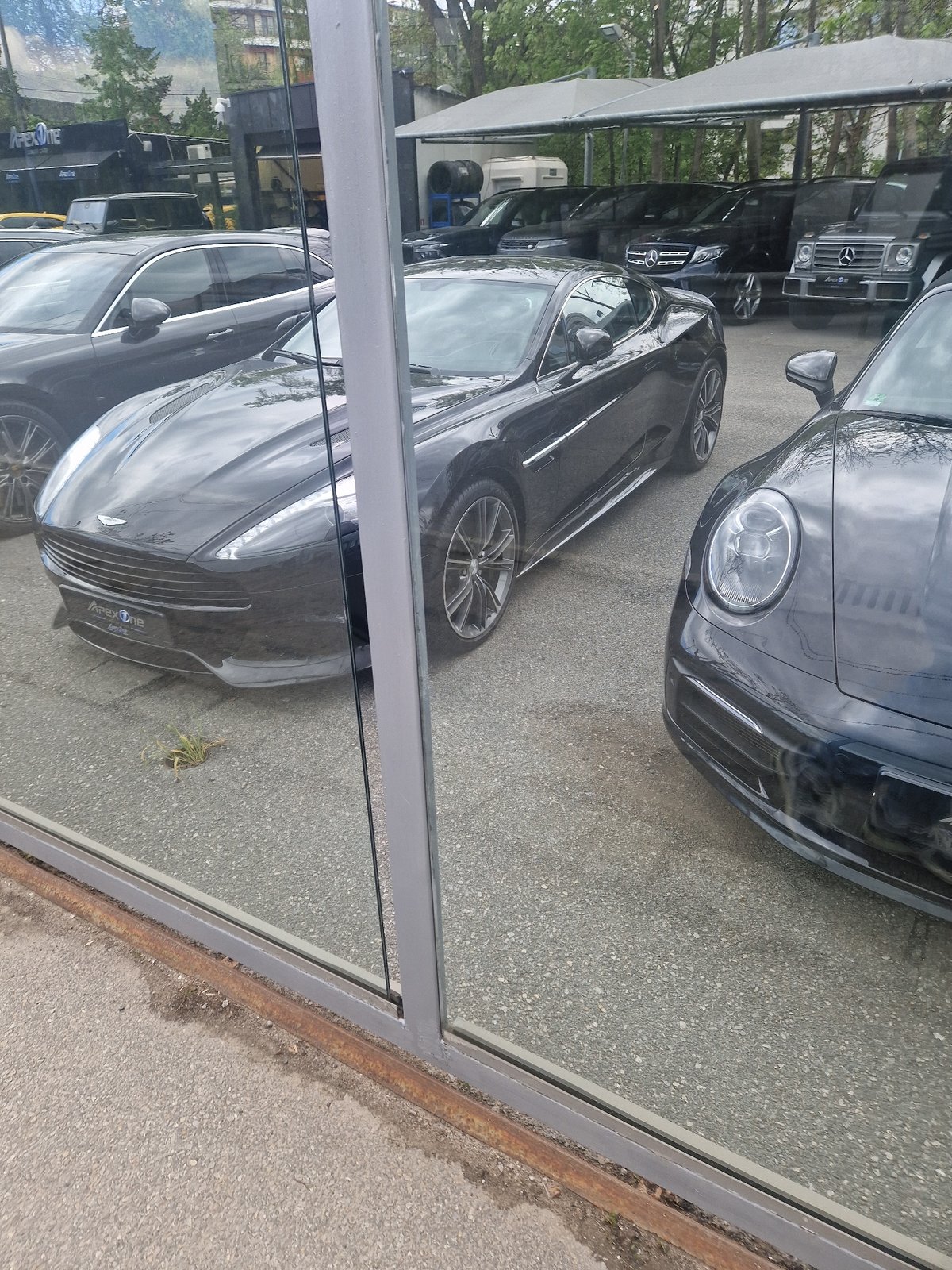 Luxury cars spotted at urban dealership during morning hours