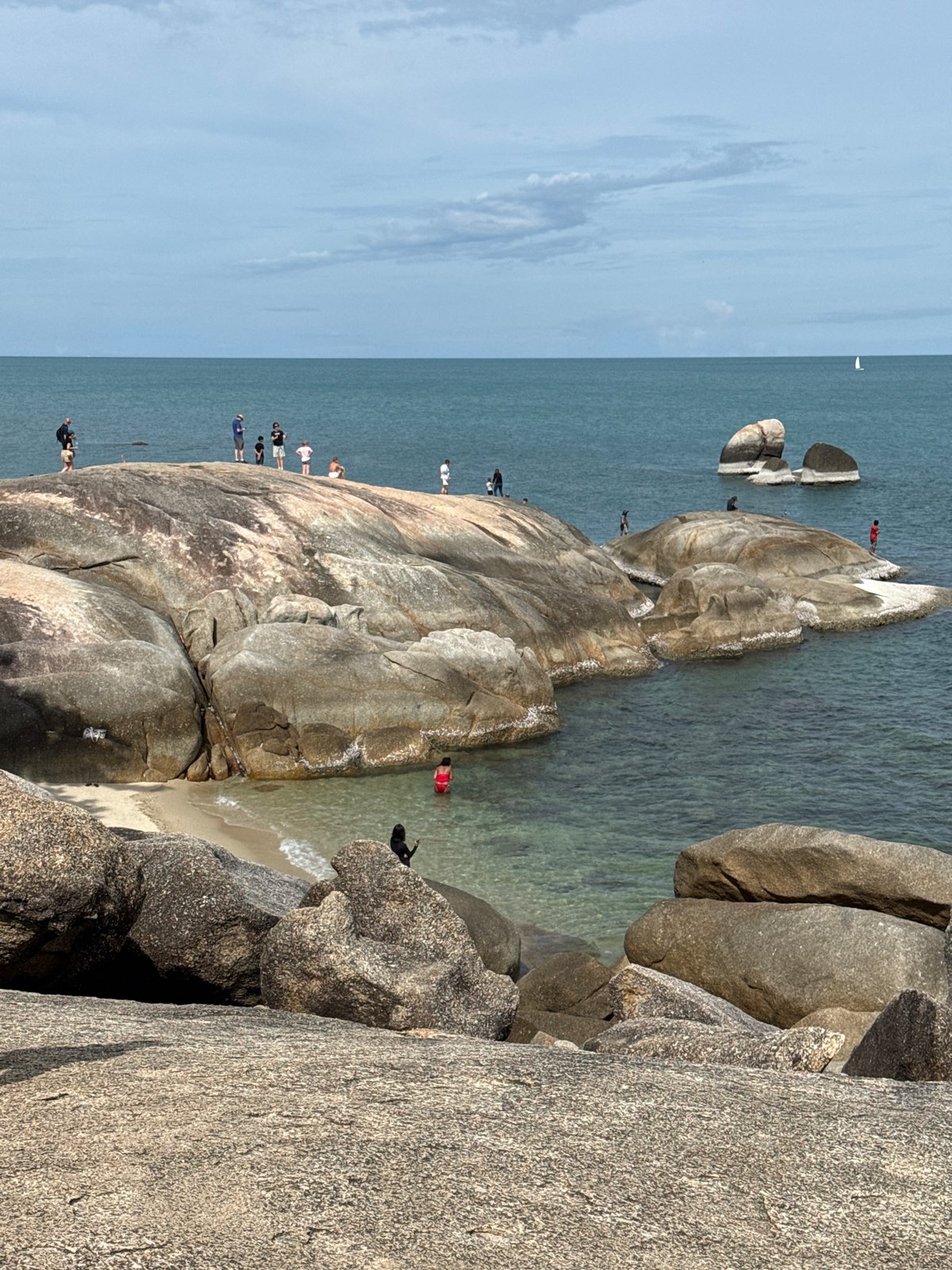 Morning hangout on the boulder-strewn shore of Baan Hua Thanon