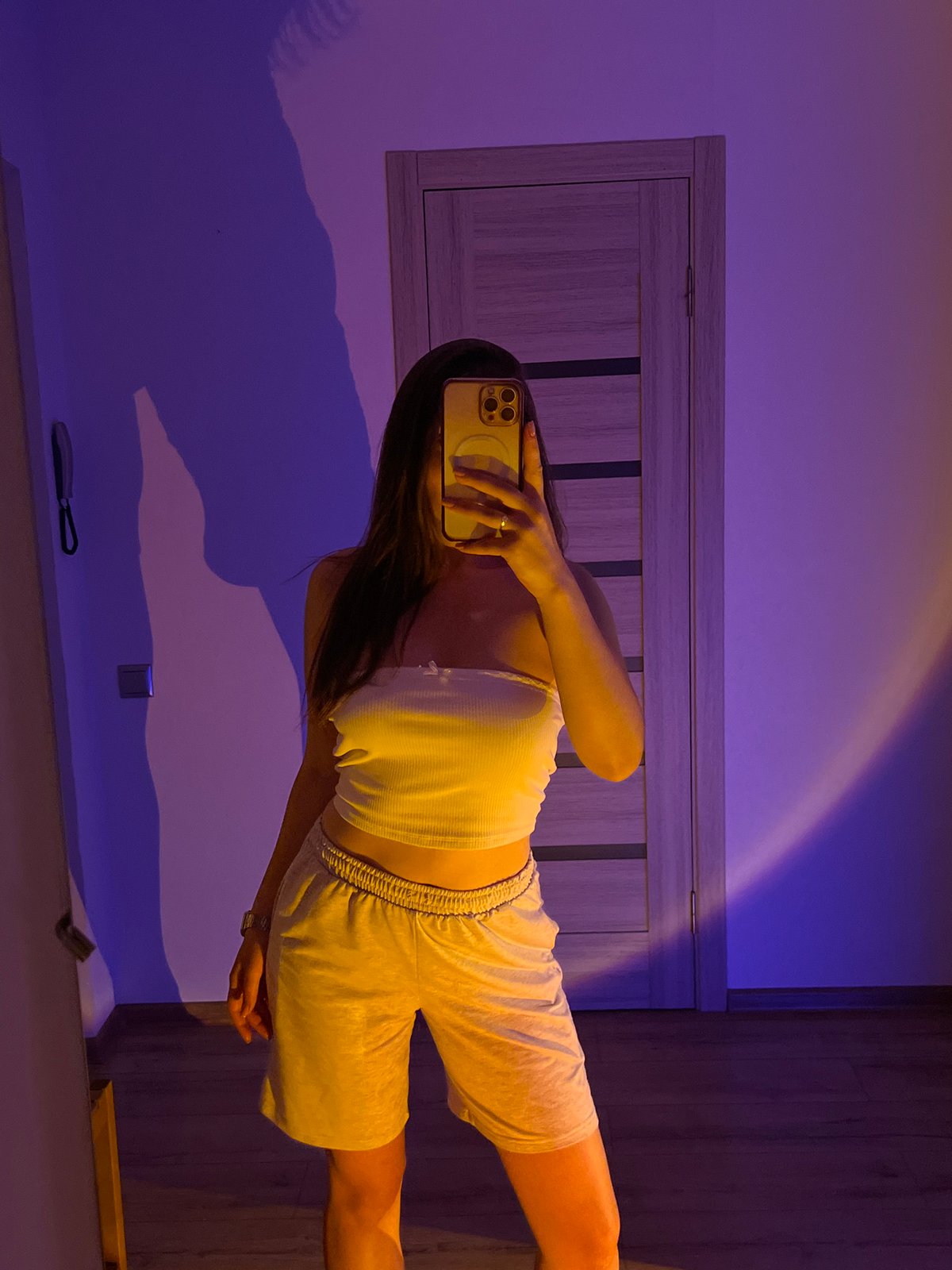 Mirror selfies and chill vibes in a purple-lit bedroom