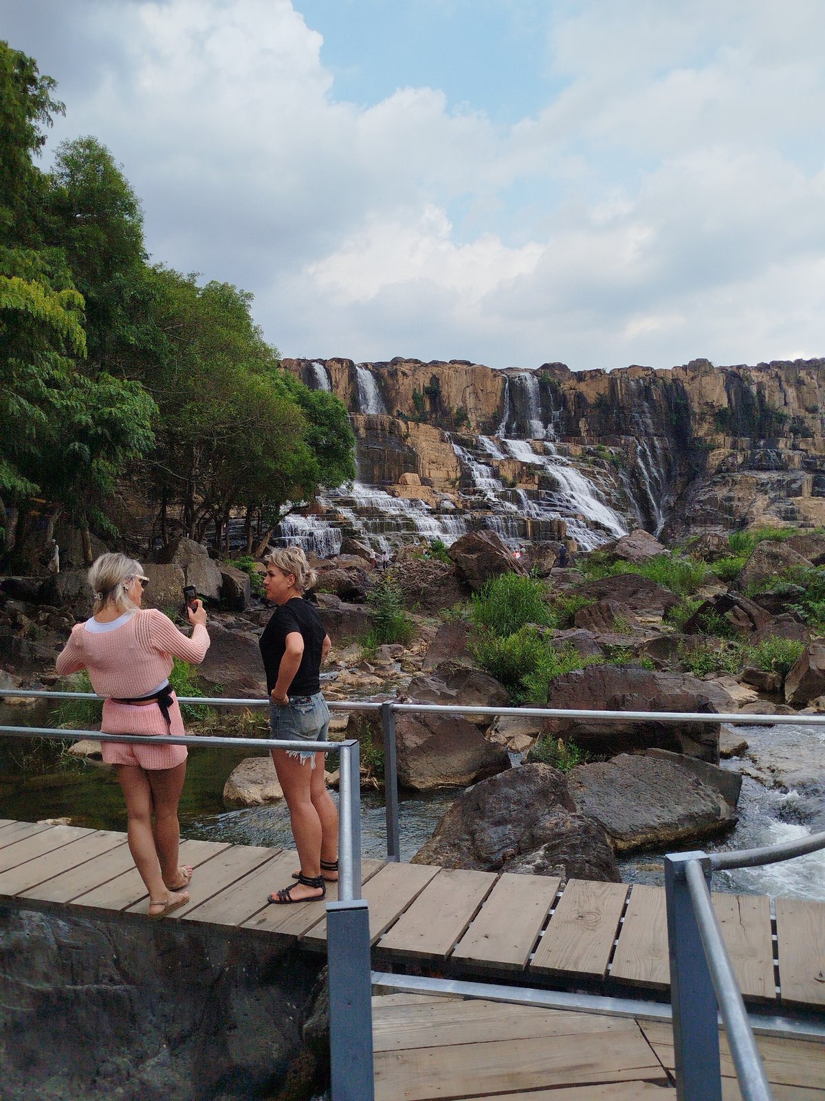 Tourists explore Pongour Waterfall during morning visit in Vietnam