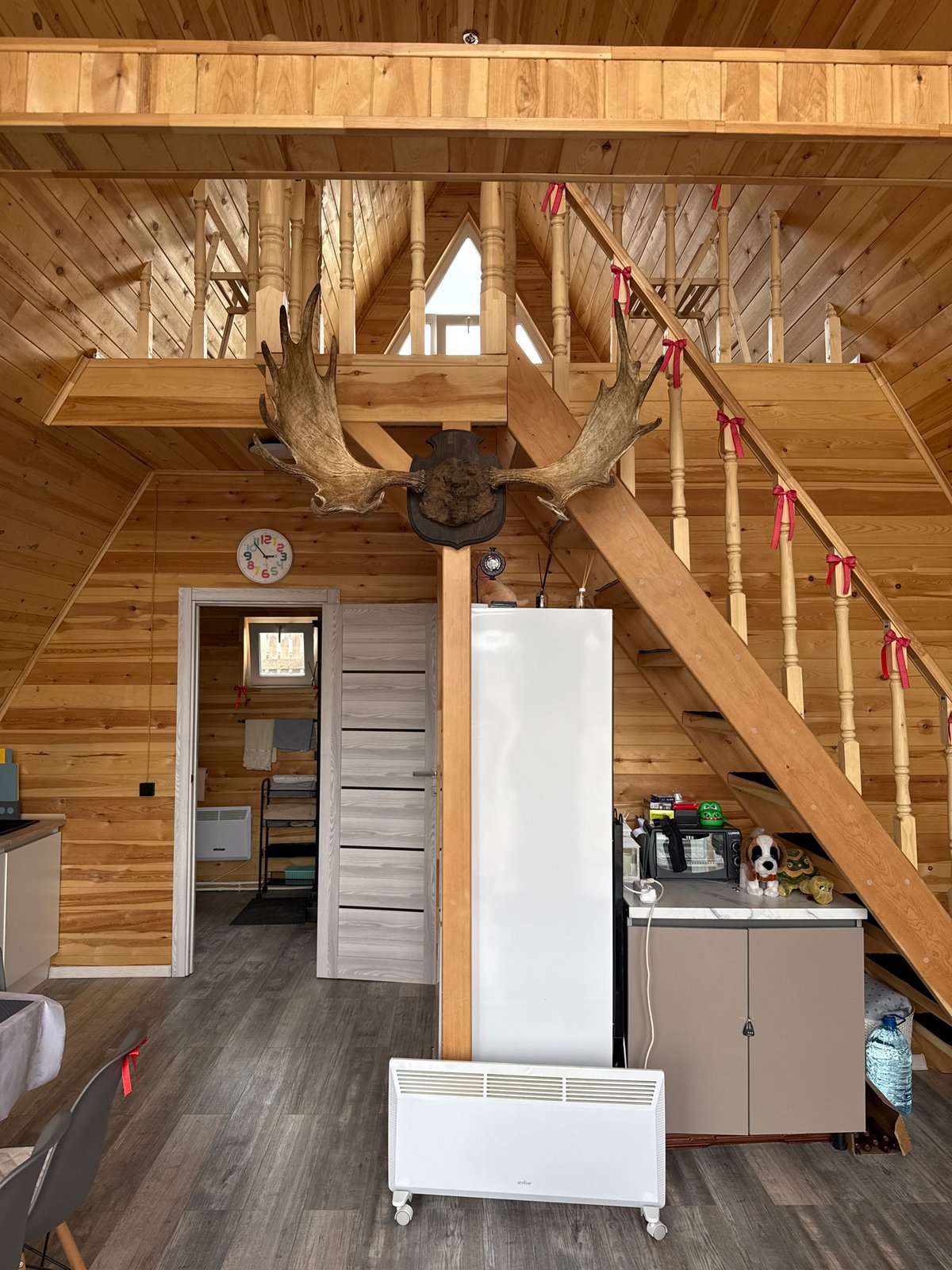 Wood-paneled interior with moose antlers observed in Krasnoyarsk