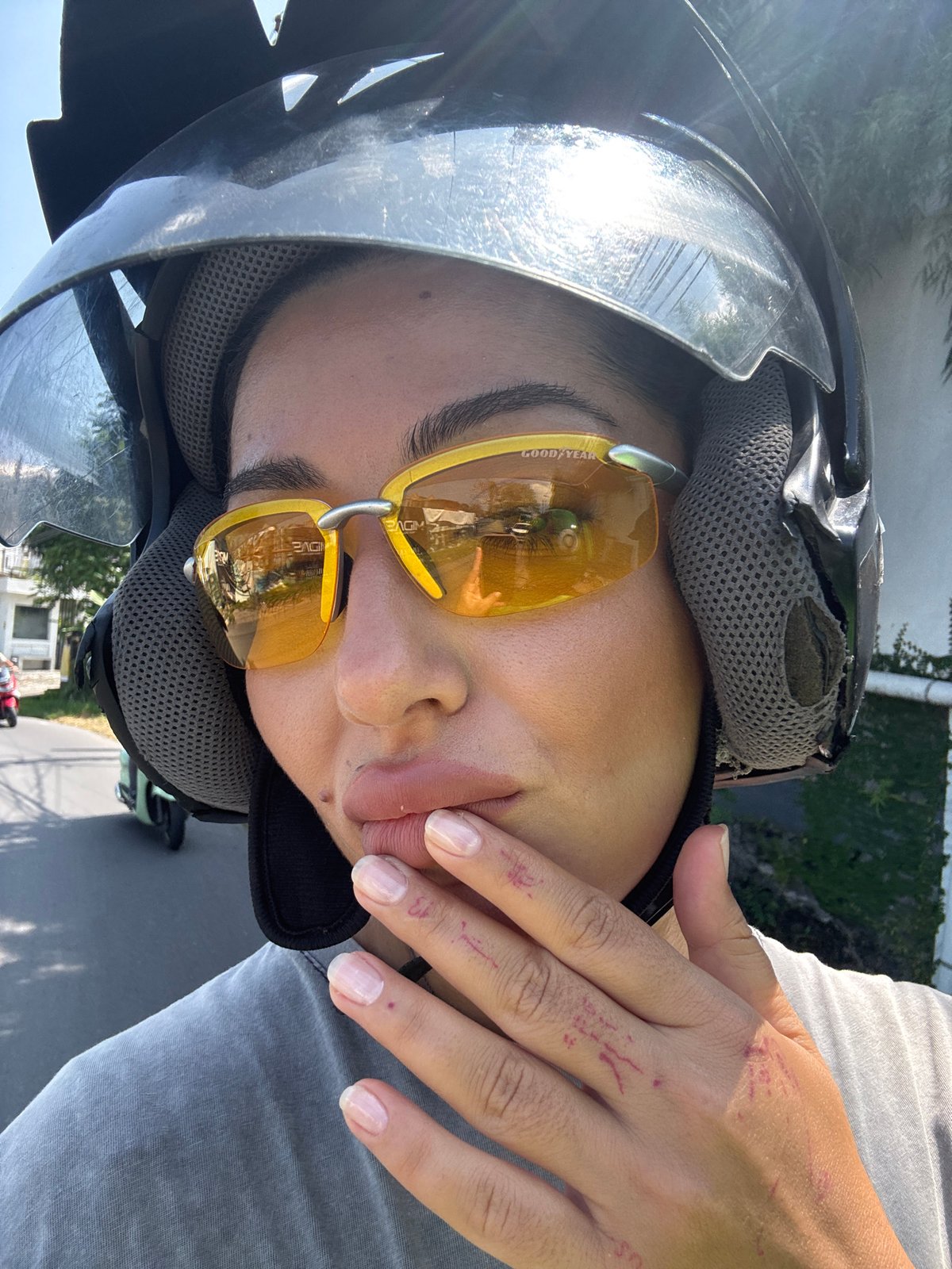 Helmeted motorcyclist photographed in daylight in North Kuta, Indonesia