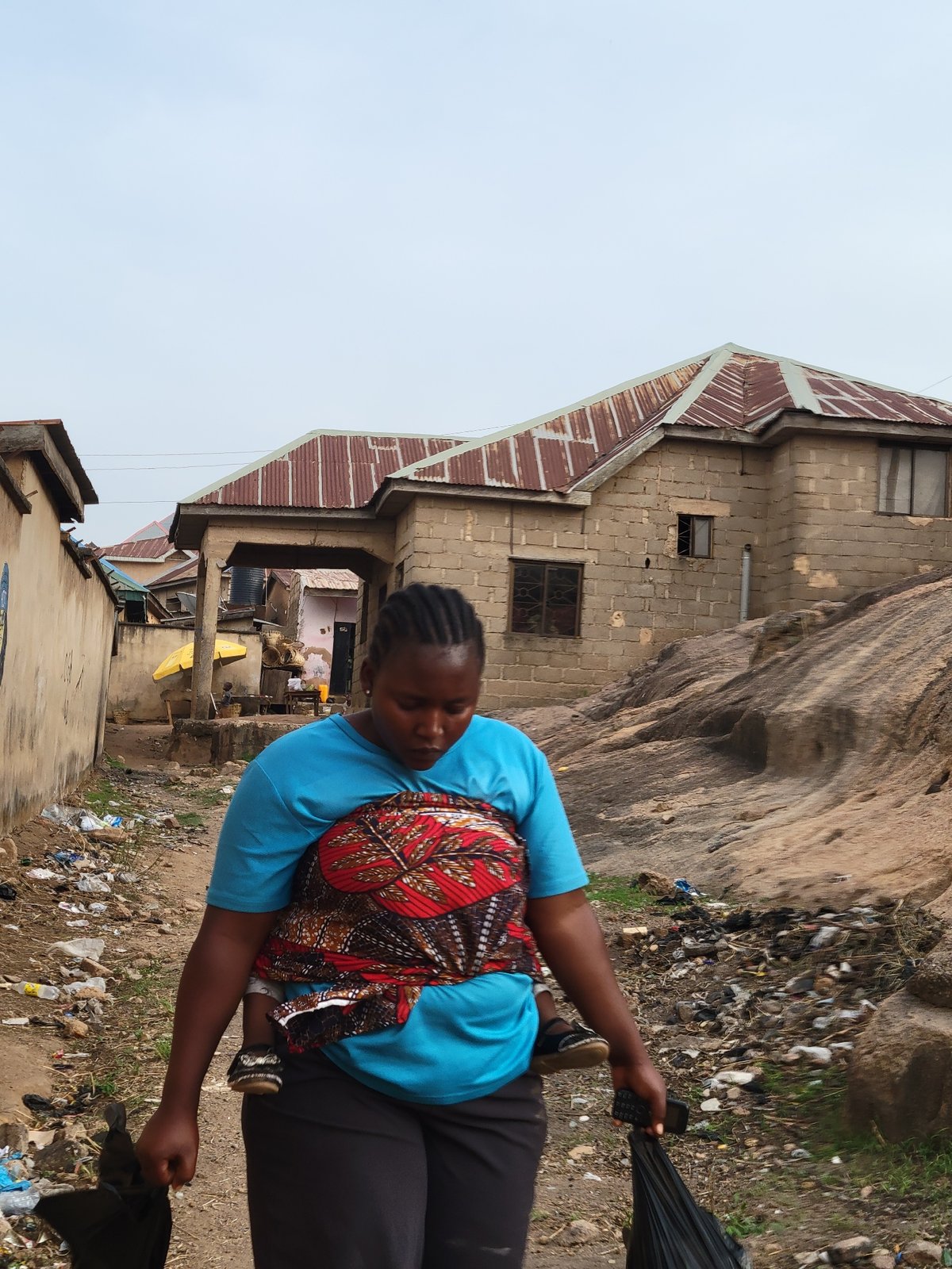 Daily life unfolds on dusty streets in Jos, Nigeria