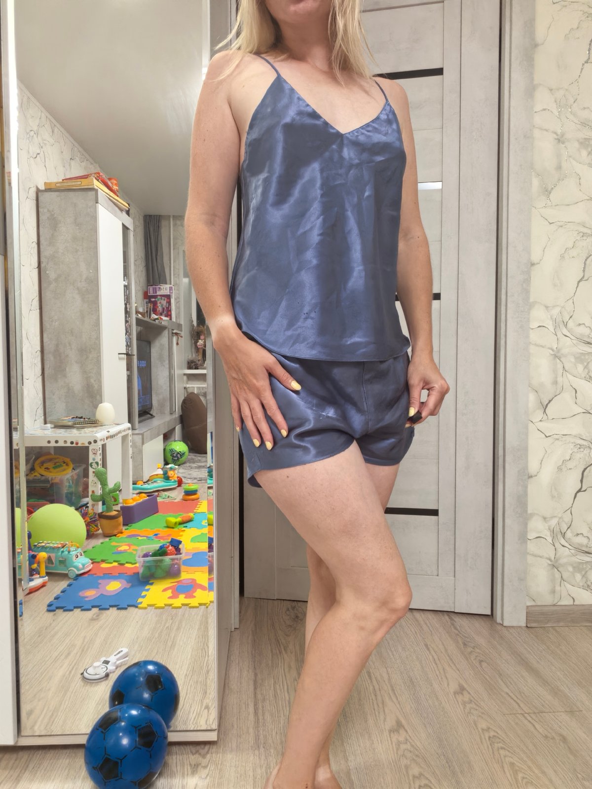 Blue satin pajama photoshoot in a Sterlitamak bedroom
