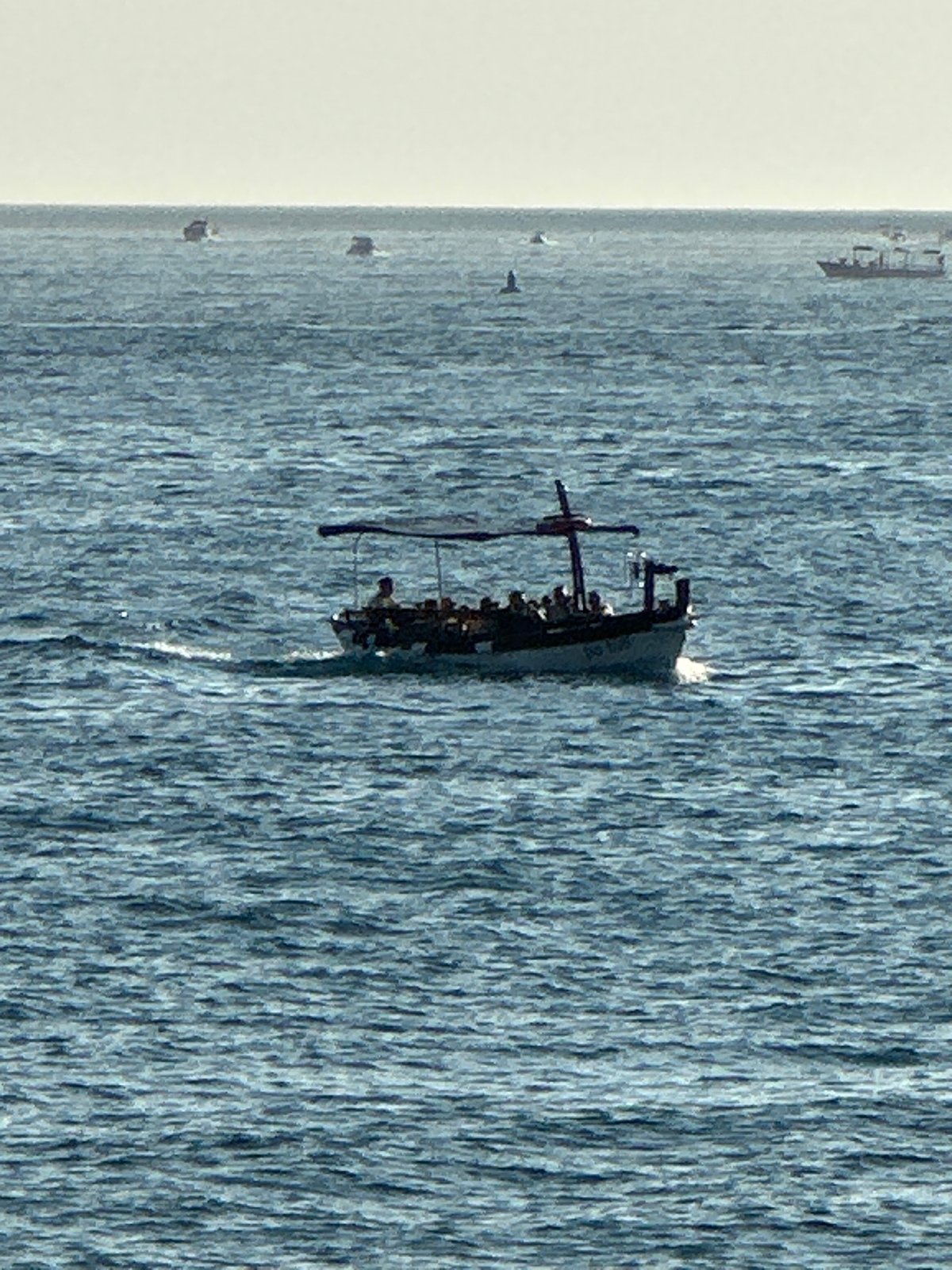 Boats and beaches along the Budva coastline on a summer afternoon
