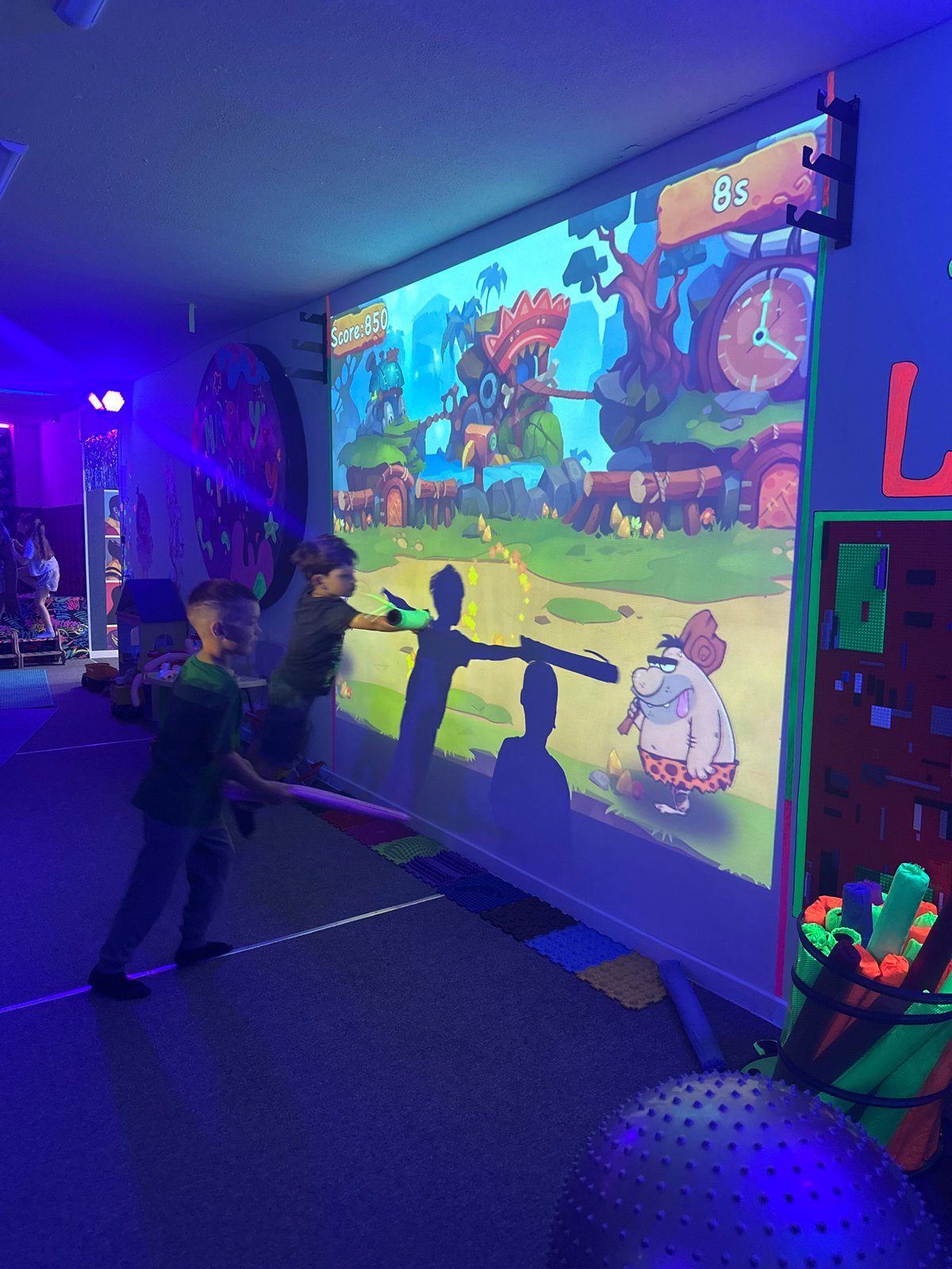Families enjoy interactive games at indoor play center