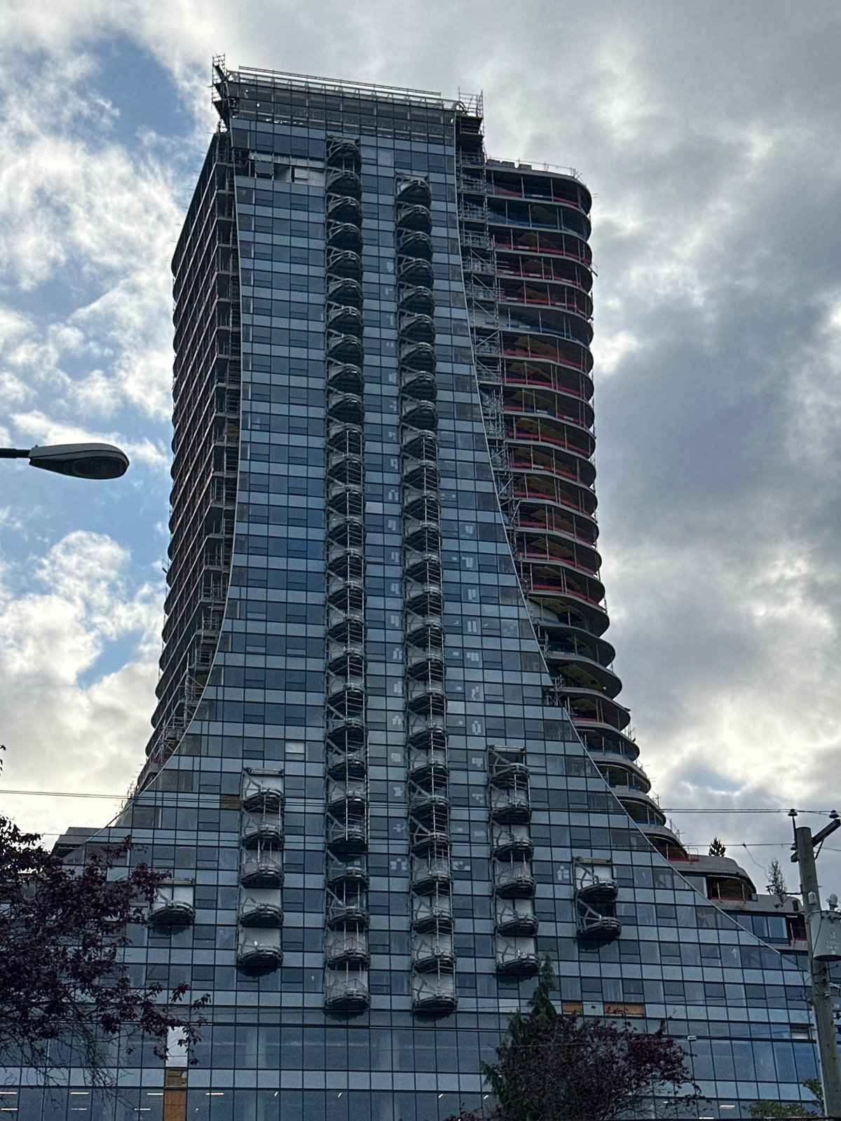 Modern curvilinear high-rise under construction documented in Vancouver