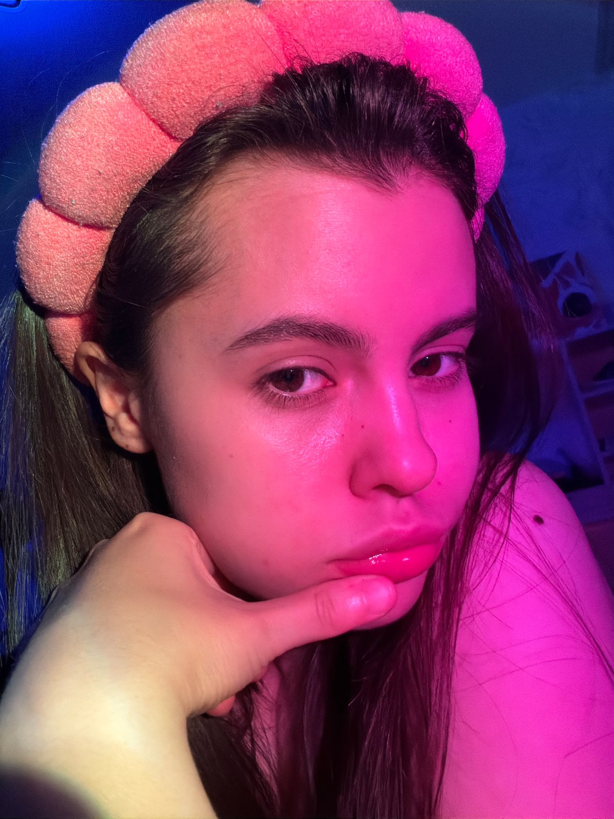 Woman photographs herself with floral accessories in Chaikovsky
