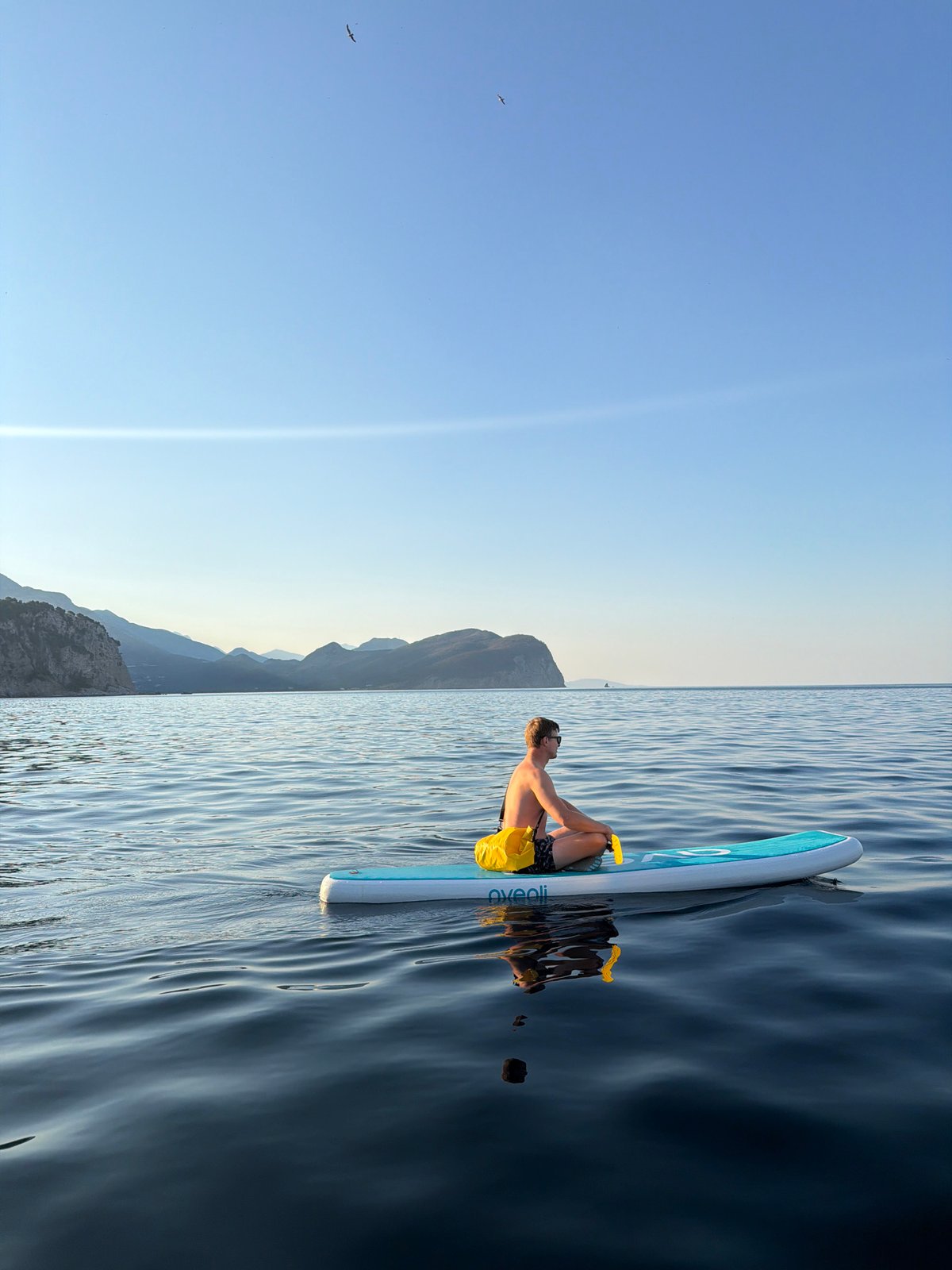 Paddleboarding around Petrovac's coastline and chapel islet