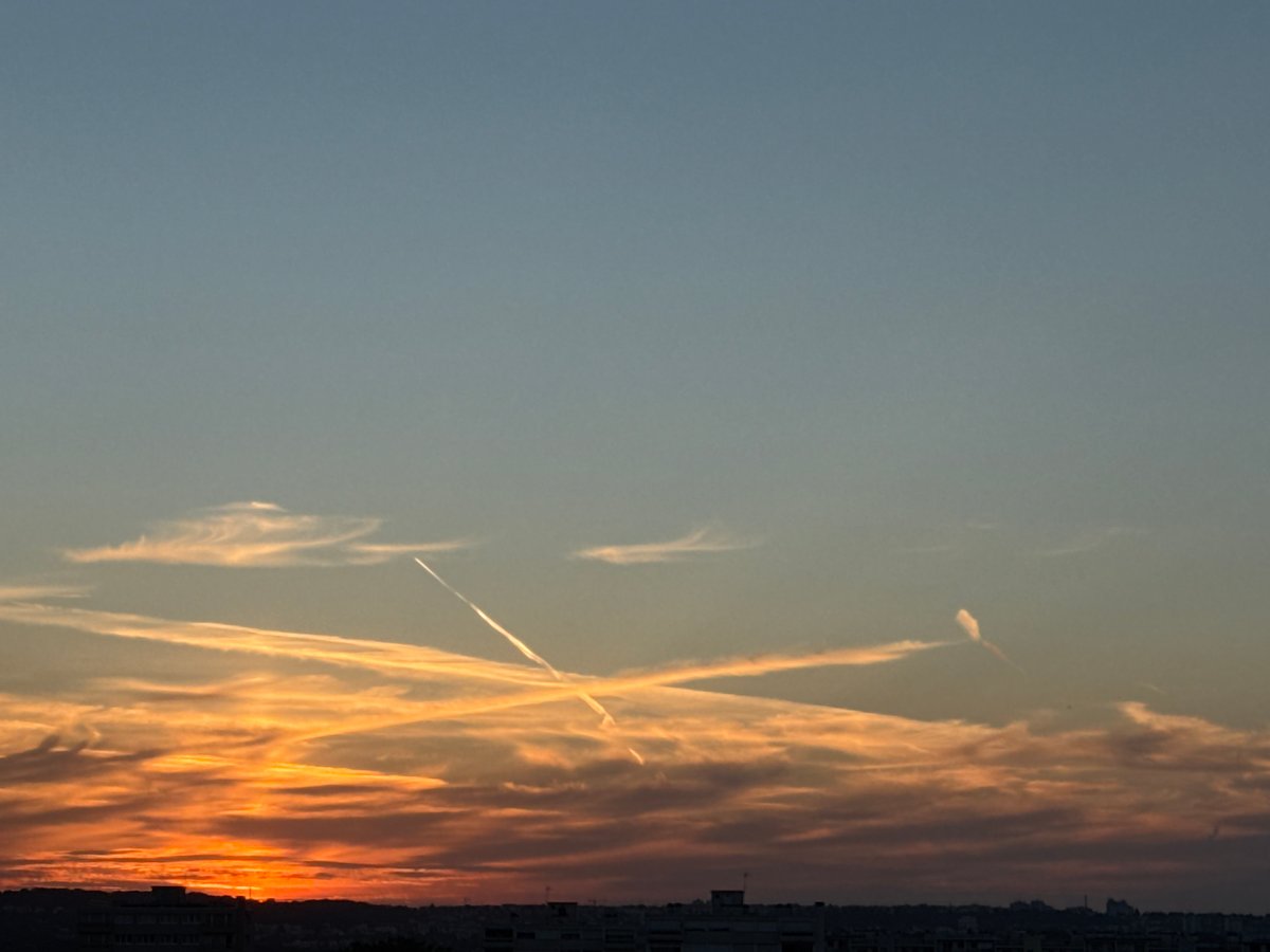 Vivid urban sunset, clouds and skyline at golden hour