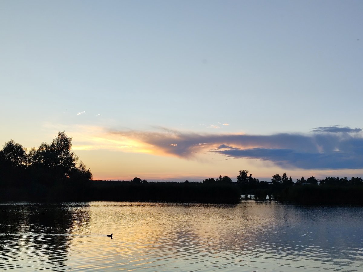 Lake at dusk, pastel sky reflected on still water