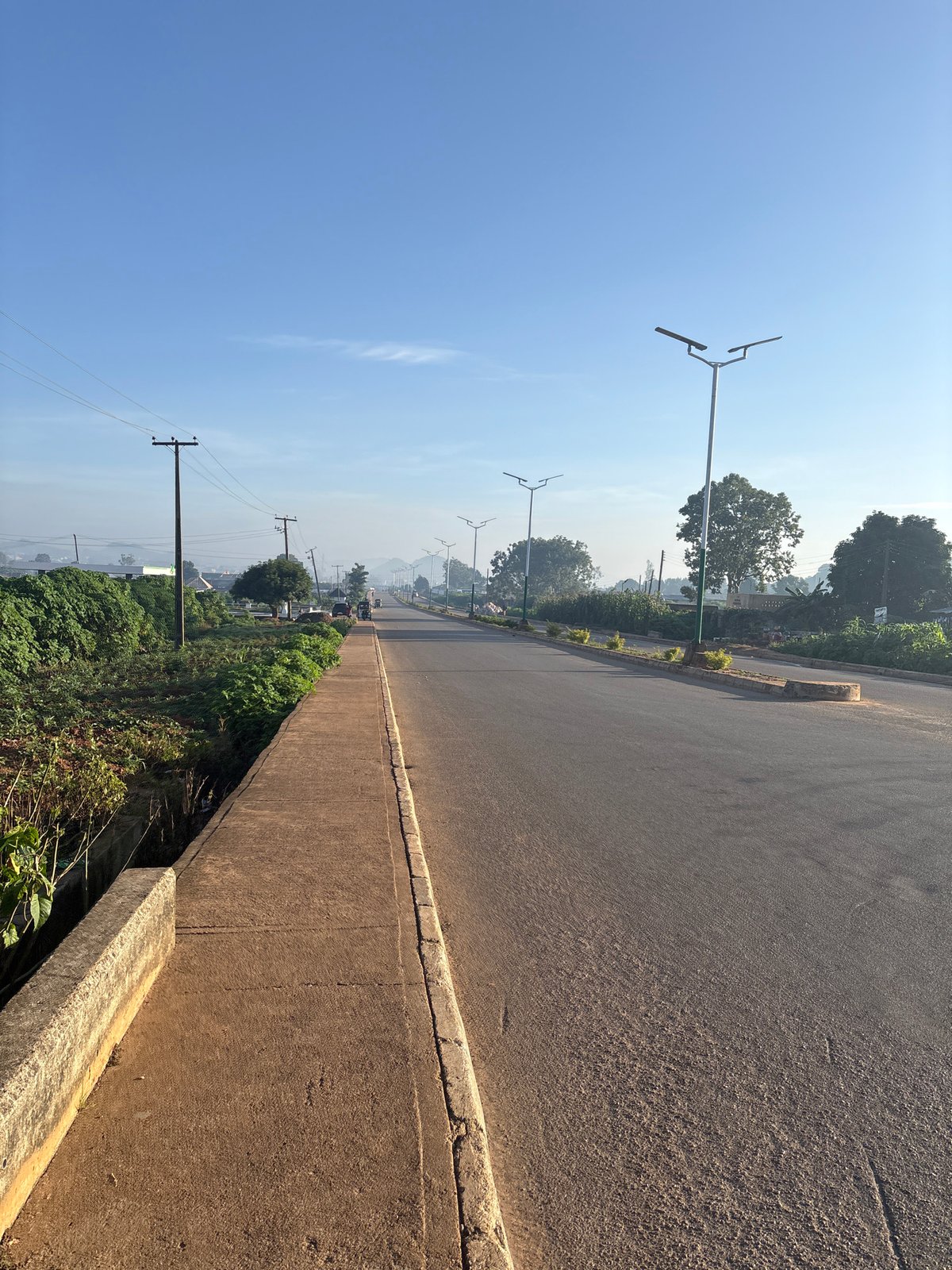 Morning street scenes along a quiet road in Bukuru, Nigeria