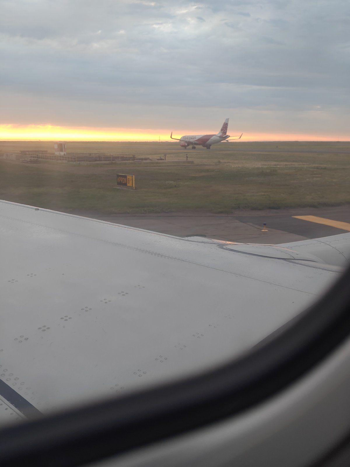 On the ground and airborne at Astana Airport around sunset