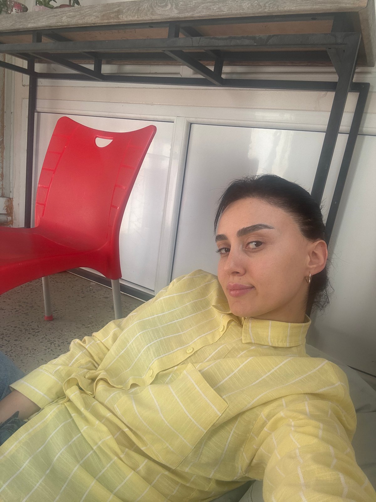 Woman photographed multiple times indoors in Tbilisi
