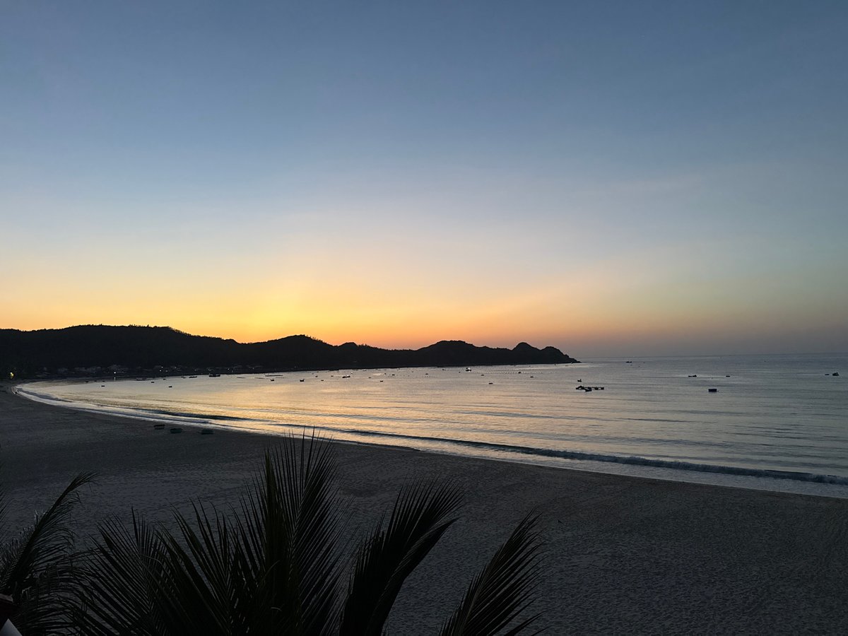 Coastal dawn, sky gradients and silhouetted hills