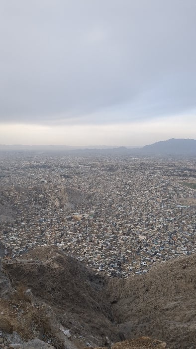 Hikers document sprawling Quetta cityscape from mountain overlooks