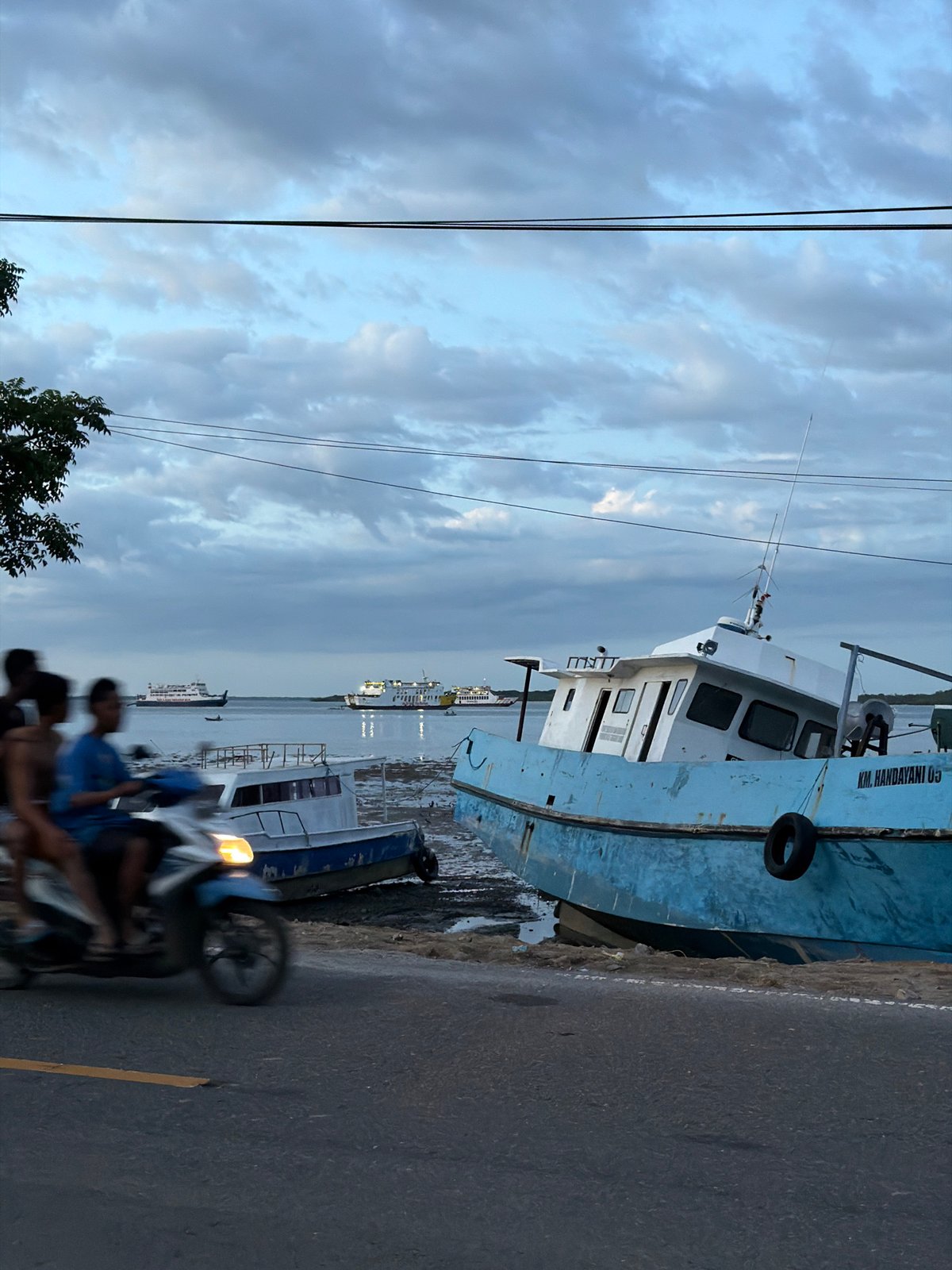 Boats beached on muddy shores in Upt Tambak Sari