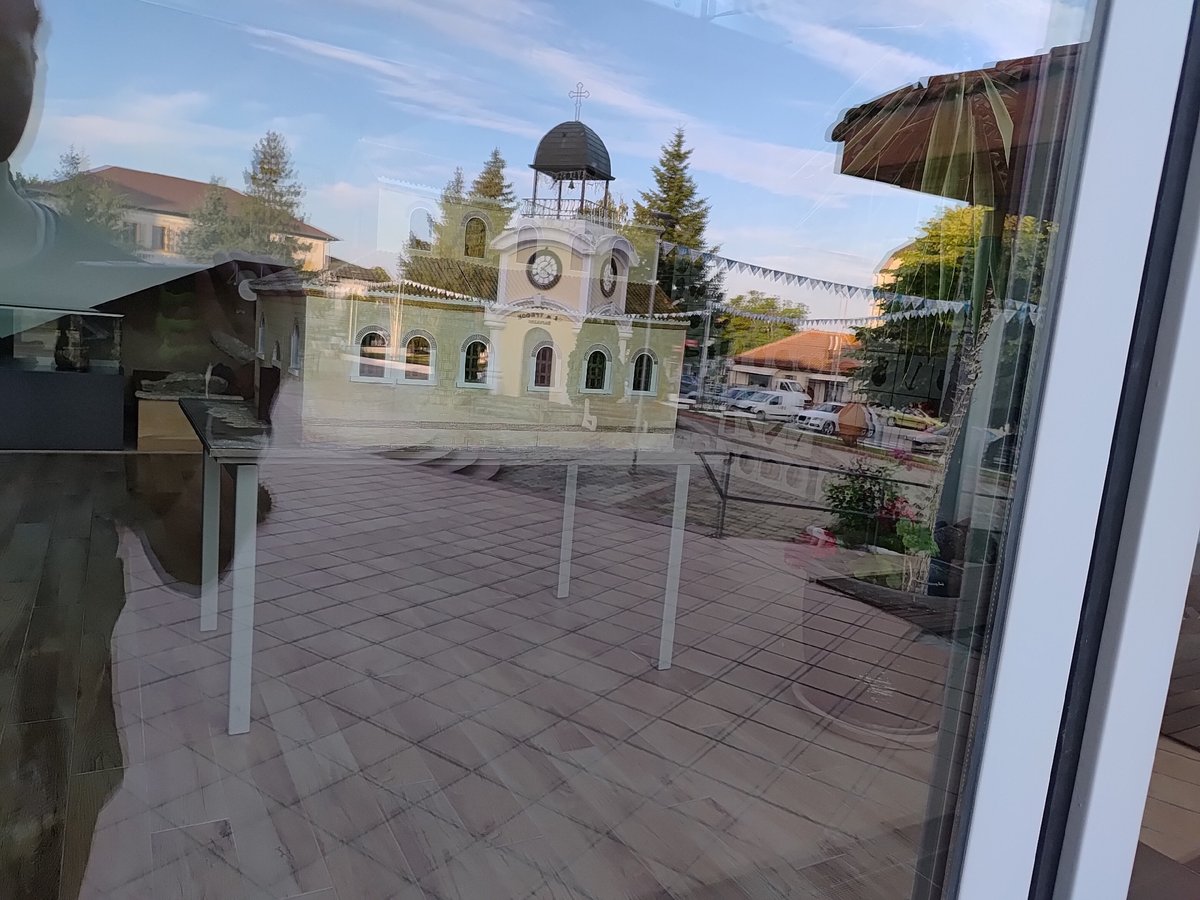 Church reflections, blooming roses, and a festive fountain square