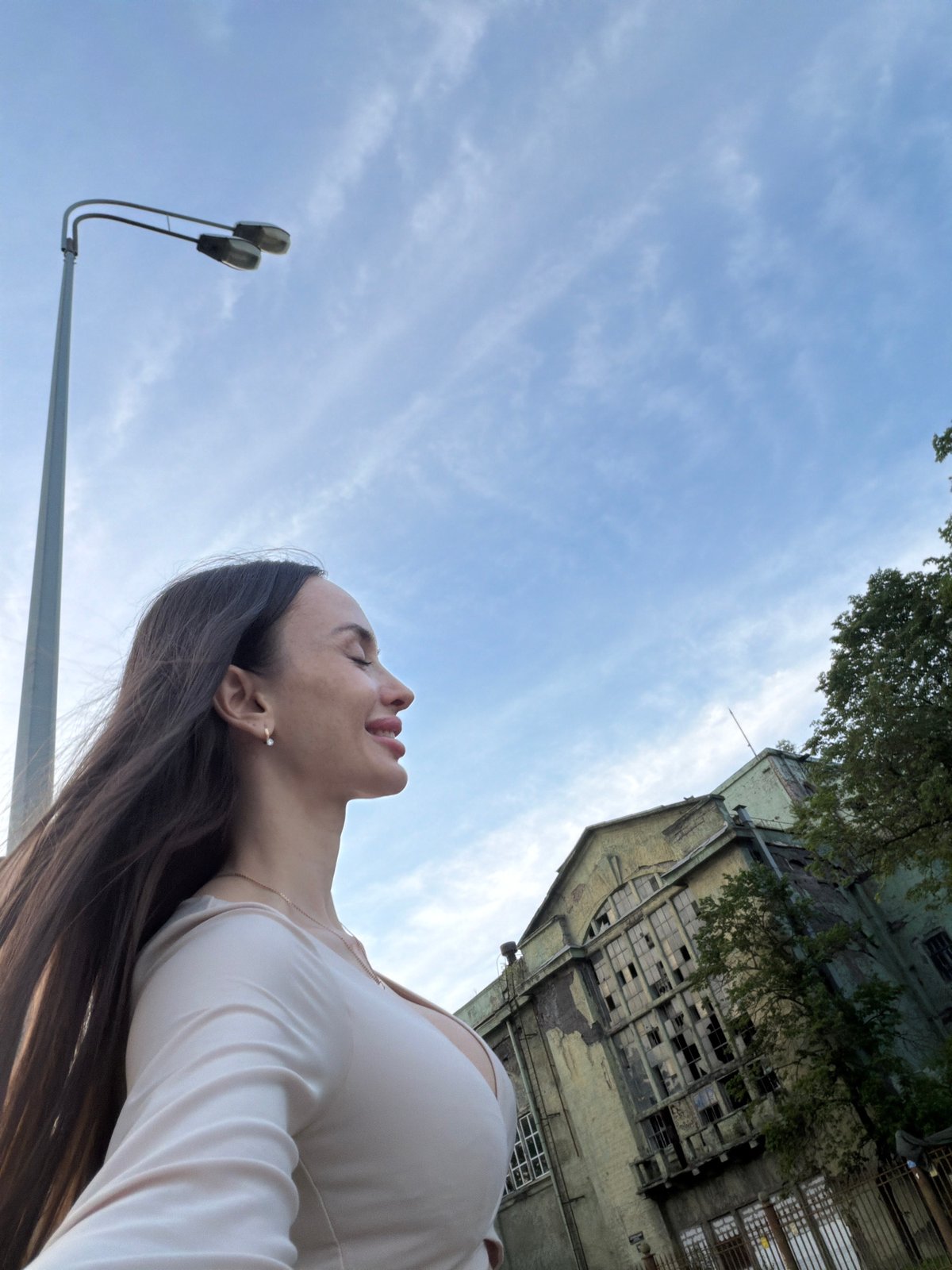 Woman photographed during riverside portrait session in Saint Petersburg