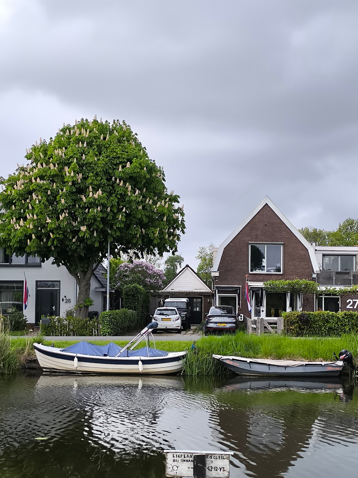 Canal boats and art sculpture documented in Netherlands region