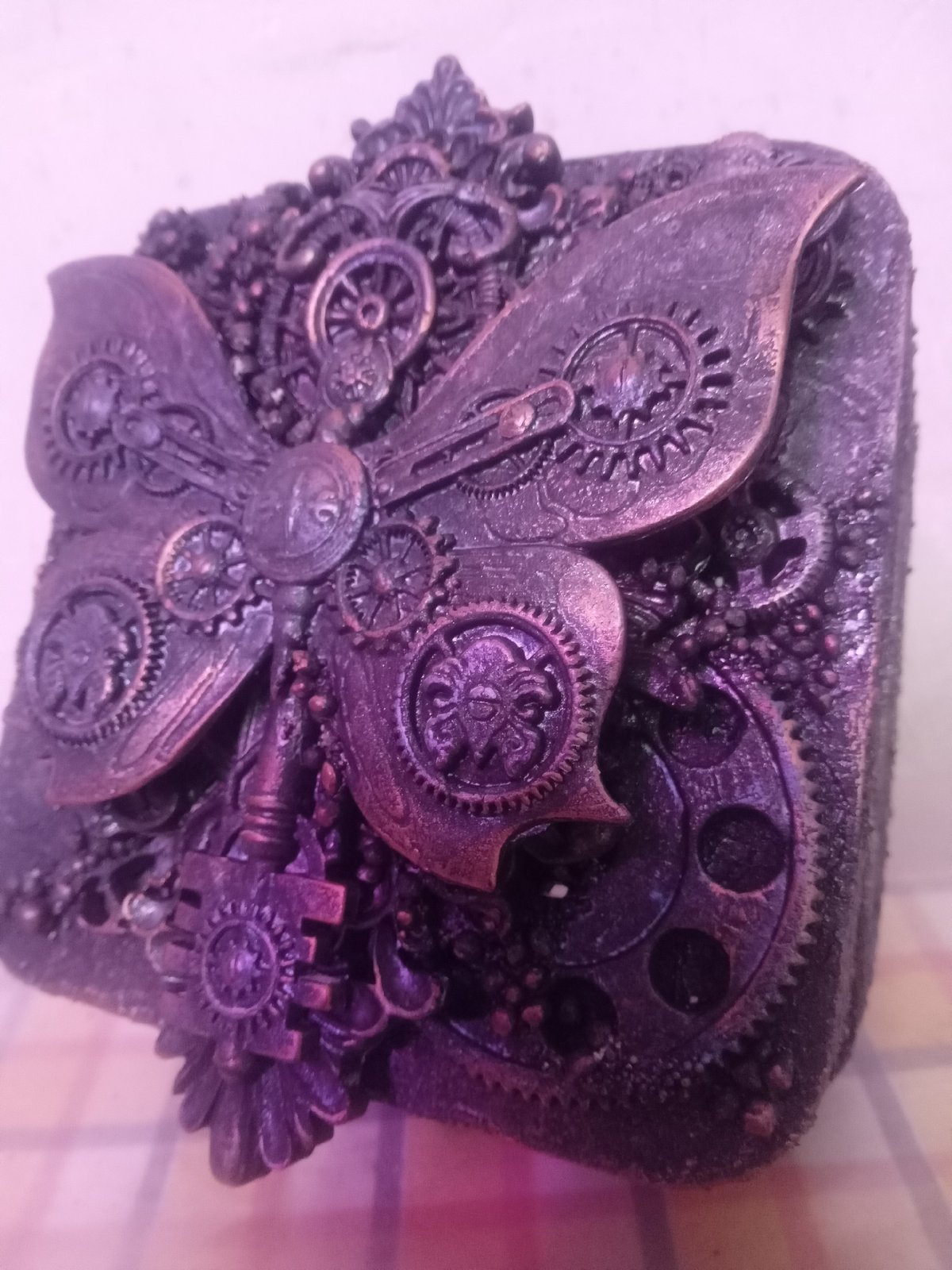 Collector documents decorative figurines and ceramic objects over evening hour