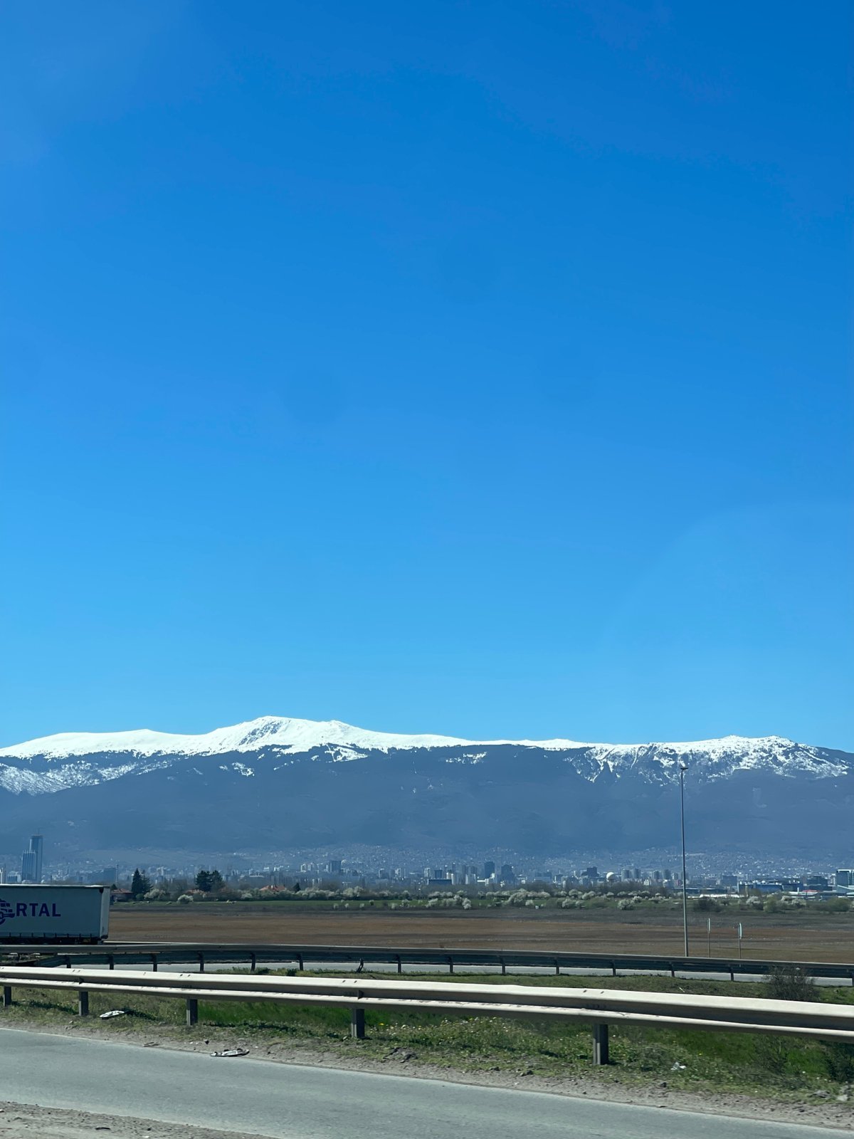 Snow-covered Vitosha Mountains viewed from highway near Sofia