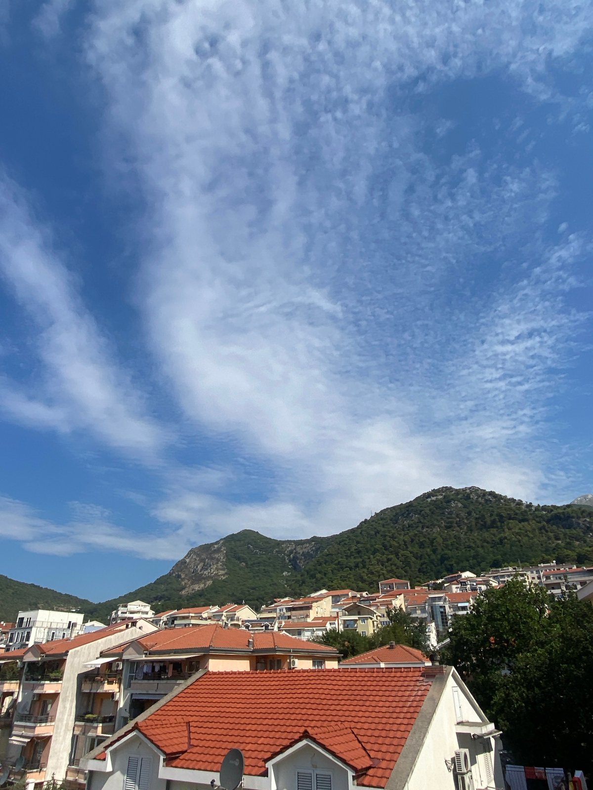 Budva's residential hillsides and mountains on a clear morning