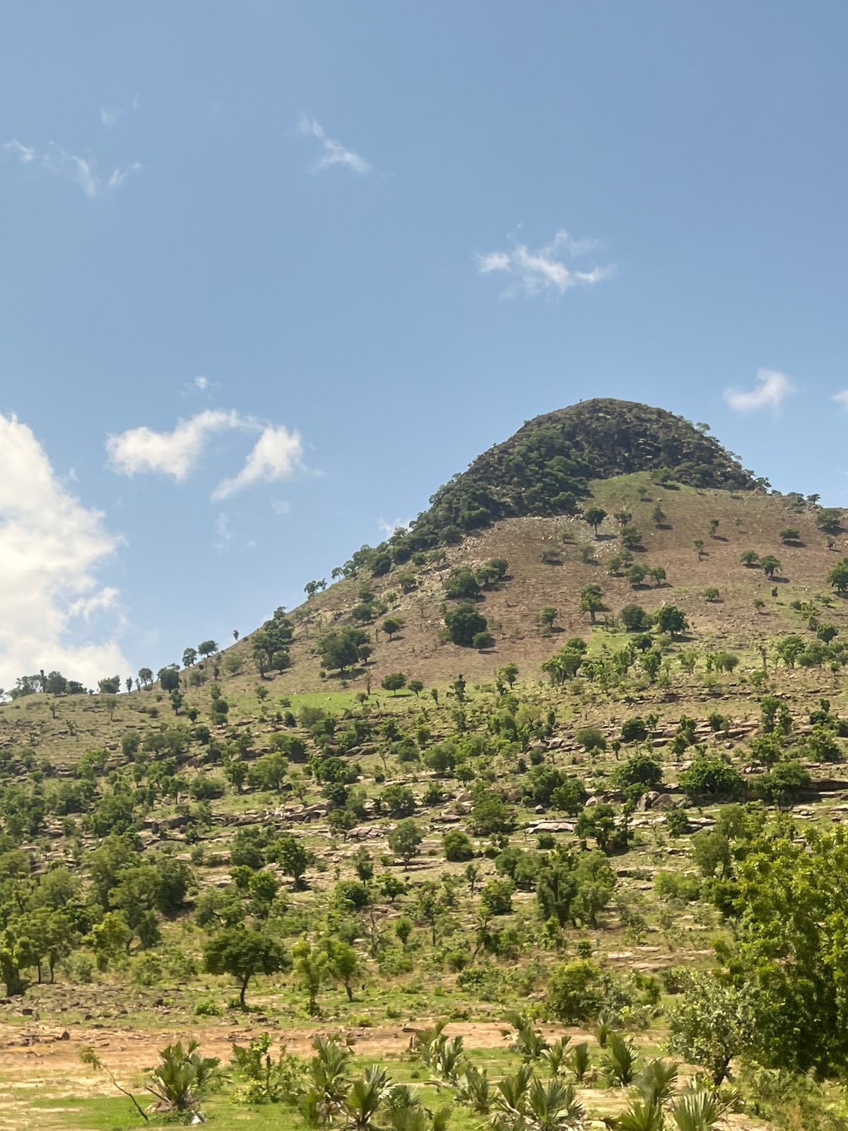 Conical hill photographed in sunlit Balanga, Nigeria landscape