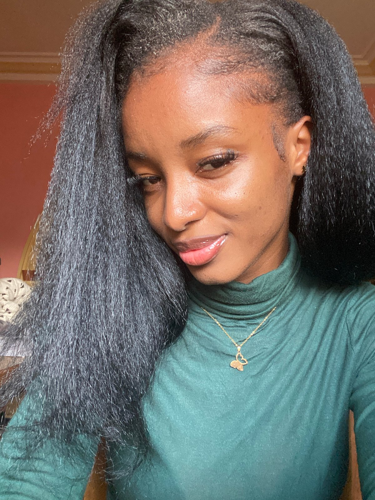 Young woman takes selfie portraits indoors in Jos, Nigeria