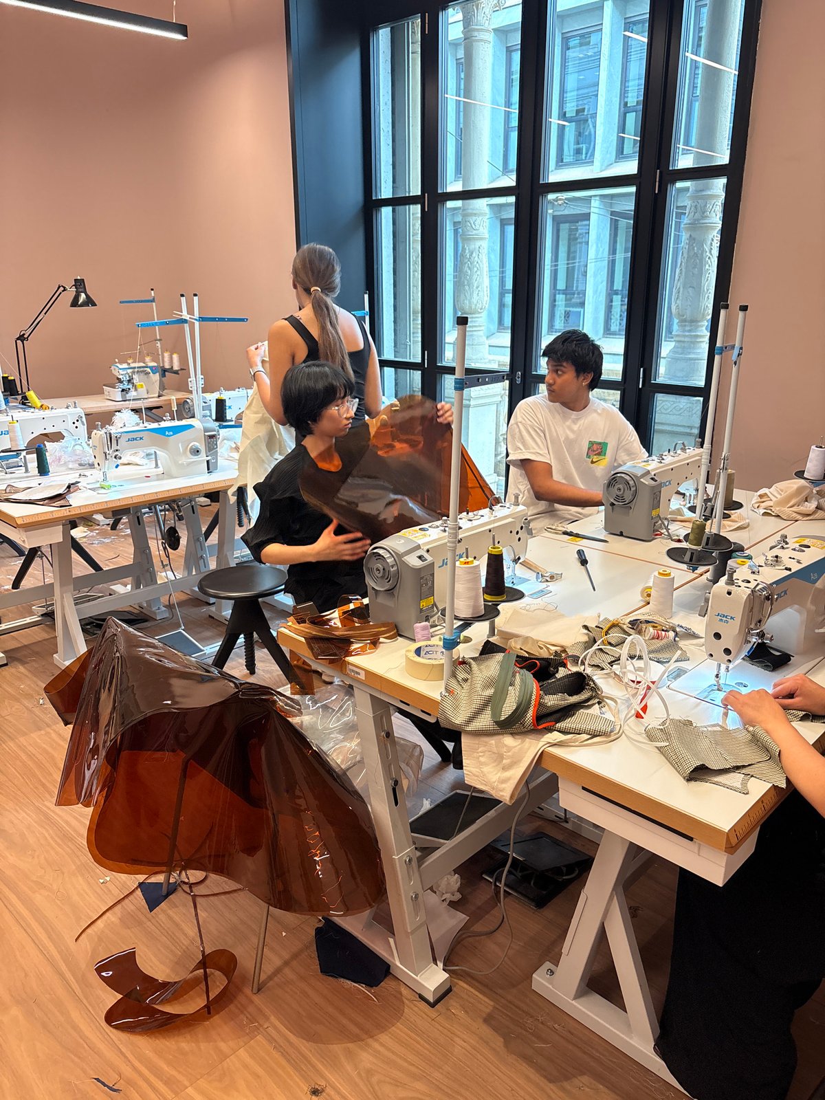 Fashion designer works in Milan studio, celebrates with cake