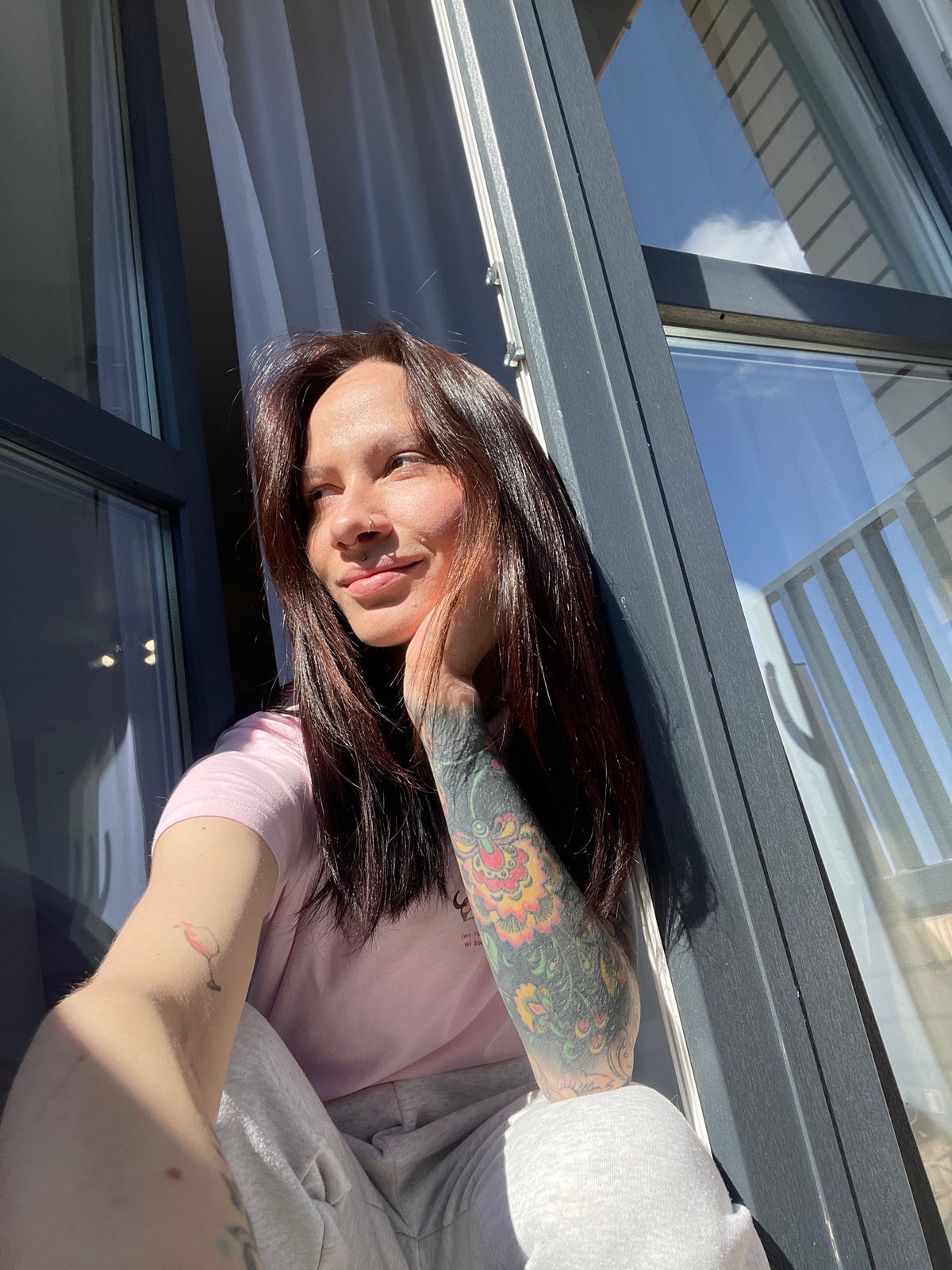 Woman photographed in sunlit indoor setting in Izhevsk