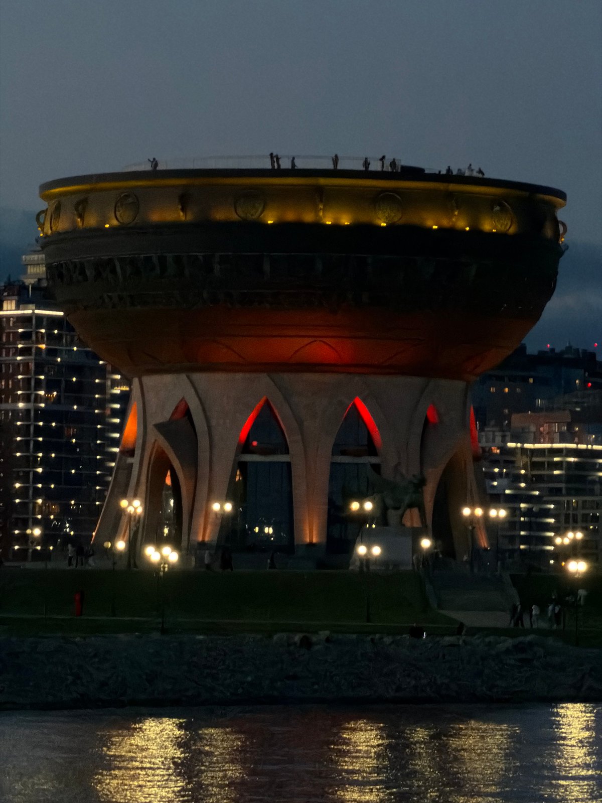Nighttime view of Kazan Family Center captured with water reflections