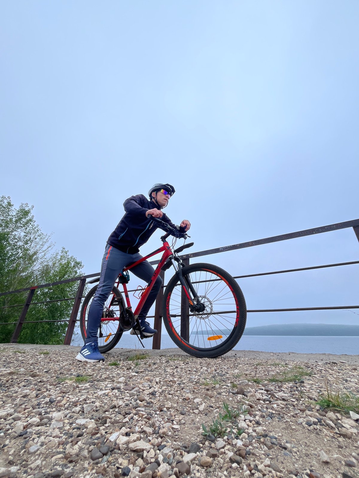 Solo cyclist rides the Kama River embankment in Chaikovsky